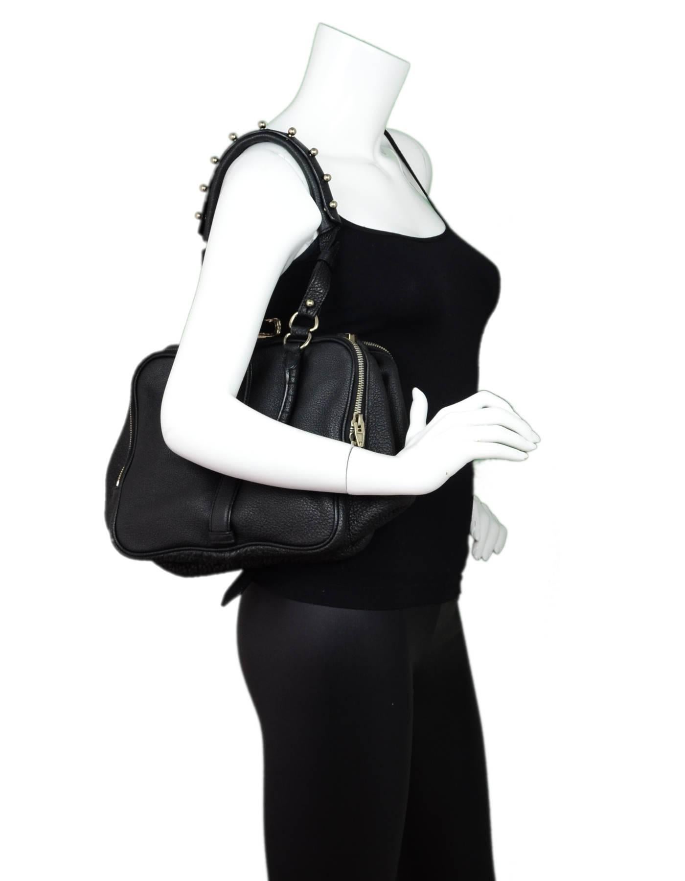 Alexander Wang Black Leather Anita Satchel

Color: Black
Materials: Leather, metal
Hardware: Silvertone
Lining: Black textile
Closure/Opening: Frame top with snap closure and center strap
Exterior Pockets: Zip compartments at each side
Interior