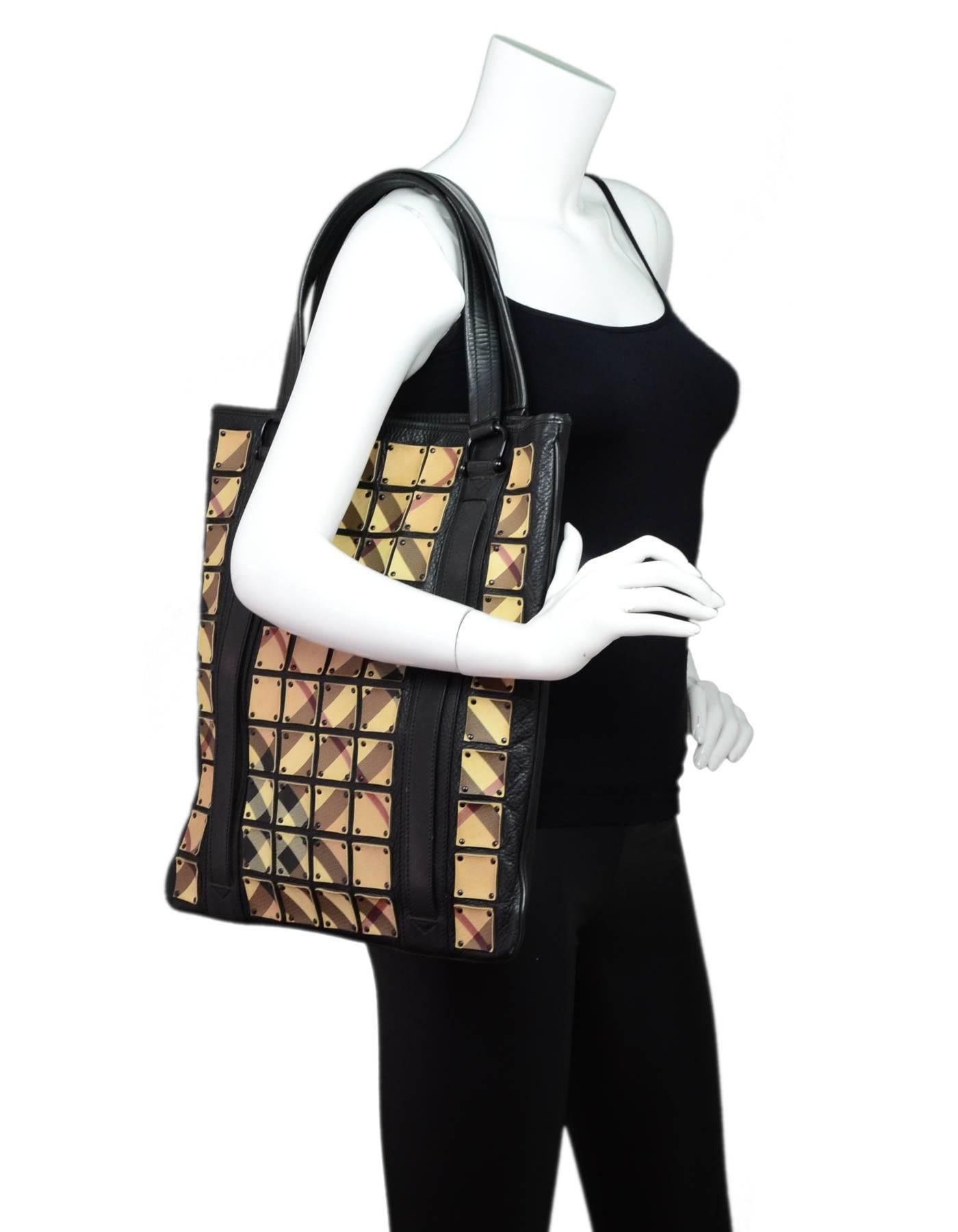Burberry Prorsum Nova Plaid Leather Tote

Made In: Italy
Color: Black, tan
Hardware: Black
Materials: Leather, metal
Lining: Tan textile
Closure/Opening: Open top with center snap
Exterior Pockets: None
Interior Pockets: One zip wall pocket, three