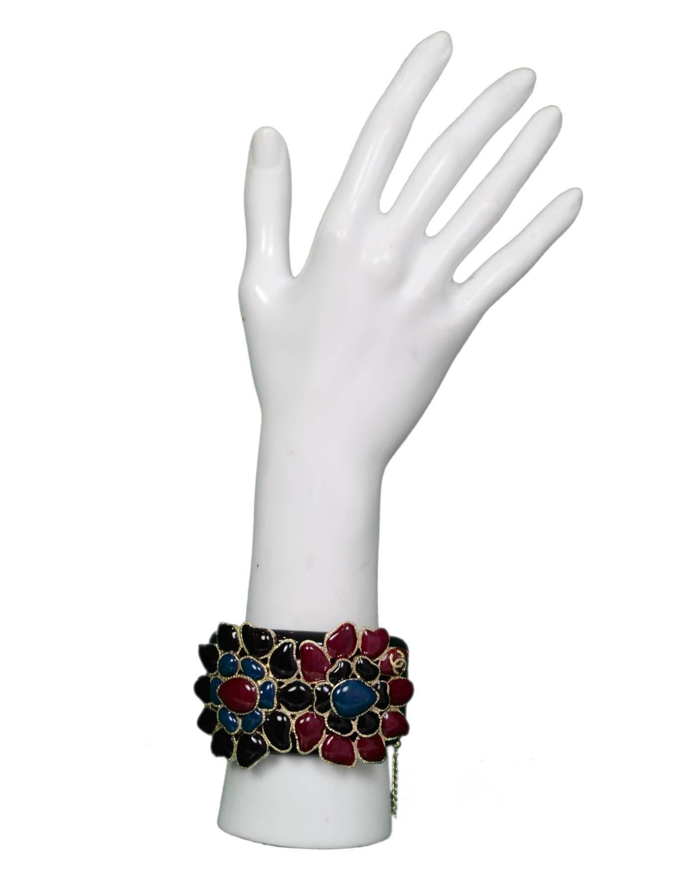 Chanel Black Resin & Glass Flowers Cuff Bracelet 

Made In: Italy
Year of Production: 2015
Materials: Resin, glass, metal
Closure/Opening: Magnetic Closure with Safety Chain
Stamp: B 15 CC C Made in Italy
Overall Condition: Excellent pre-owned