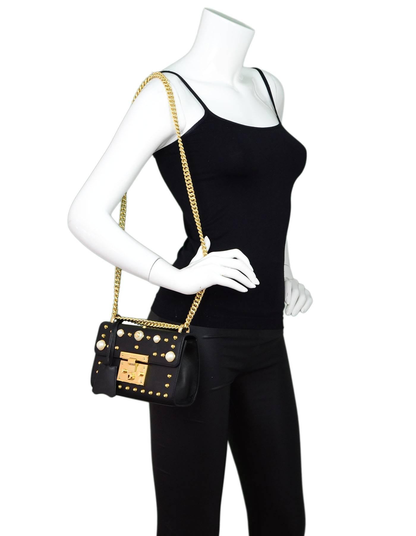 Gucci Black Leather & Faux Pearl Studded Padlock Shoulder Bag

Made In: Italy
Color: Black, gold, white
Hardware: Goldtone
Materials: Leather, faux pearl, metal
Lining: Beige suede
Closure/Opening: Flap top with push-lock
Exterior Pockets: