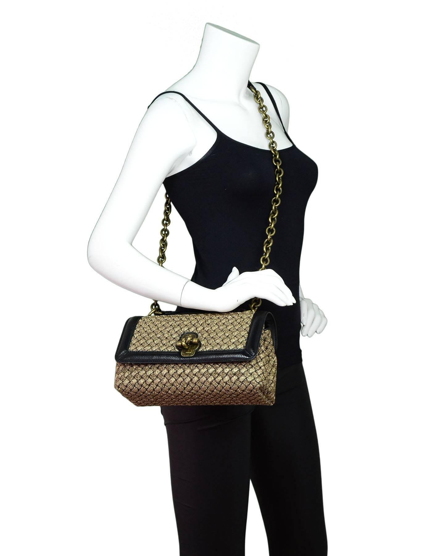 Bottega Veneta Black & Gold Olimpia Woven Knot Bag

Made In: Italy
Color: Black, gold
Hardware: Brass
Materials: Woven metallic wool, black Karung snakeskin trim
Lining: Taupe suede
Closure/Opening: Flap top with front twist-lock
Exterior Pockets: