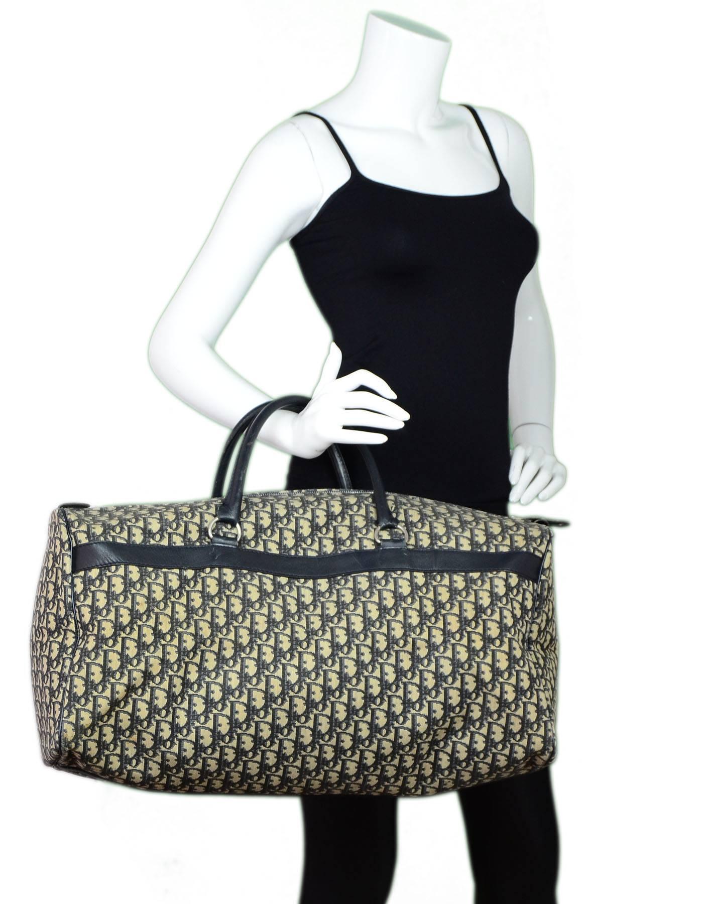 Dior Vintage Navy & Beige Monogram Canvas Boston Duffel Bag 
Features leather trim and piping throughout exterior

Made In: France
Color: Blue and beige
Hardware: Silvertone
Materials: Canvas and leather
Lining: Dark navy vinyl
Closure/Opening: Zip