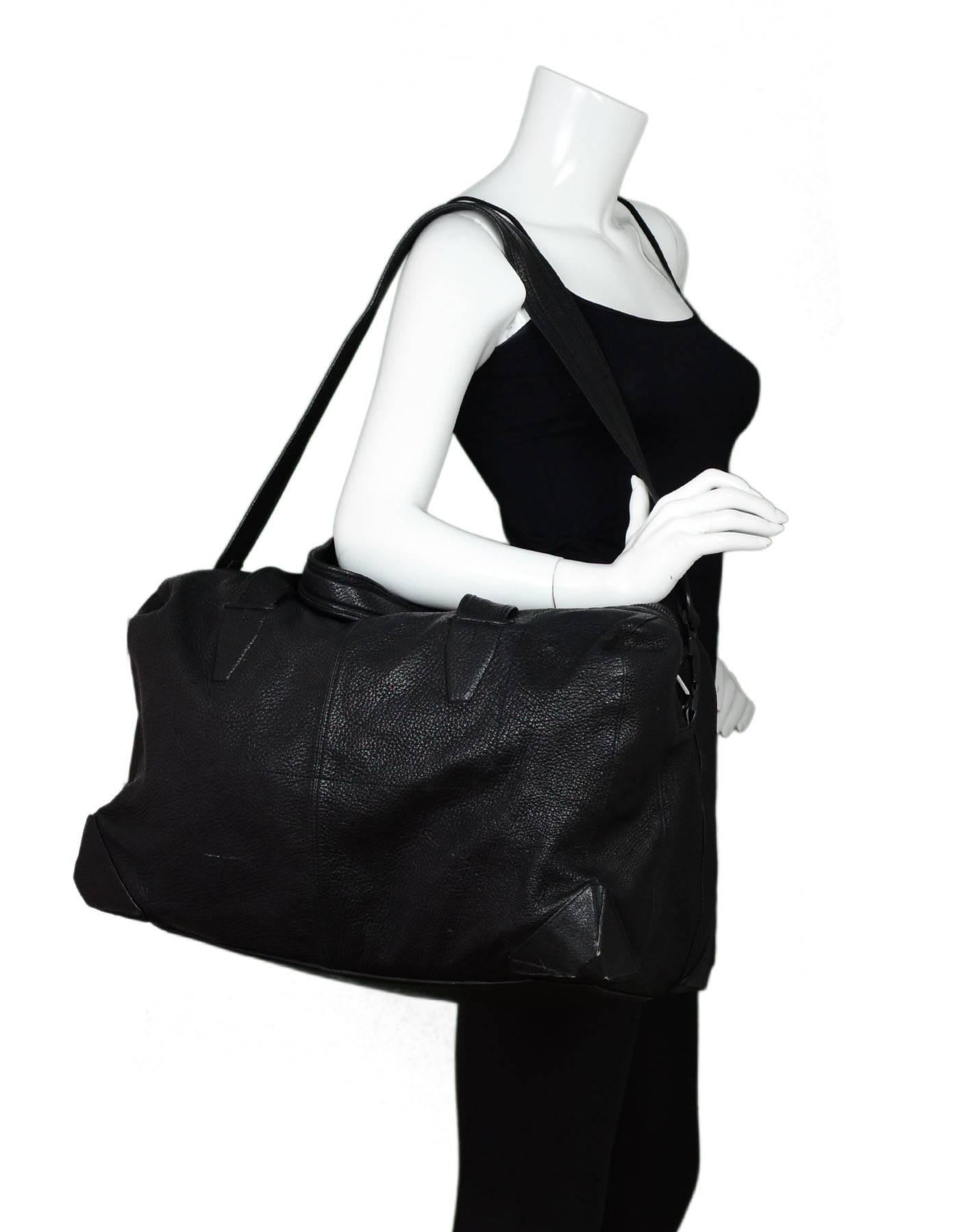 Alexander Wang Black Leather Wallie Duffle Bag

Color: Black
Materials: Leather, metal
Hardware: Black
Lining: Black textile
Closure/Opening: Zip top closure
Exterior Pockets: Two zip compartments 
Interior Pockets: Two wall pockets in one