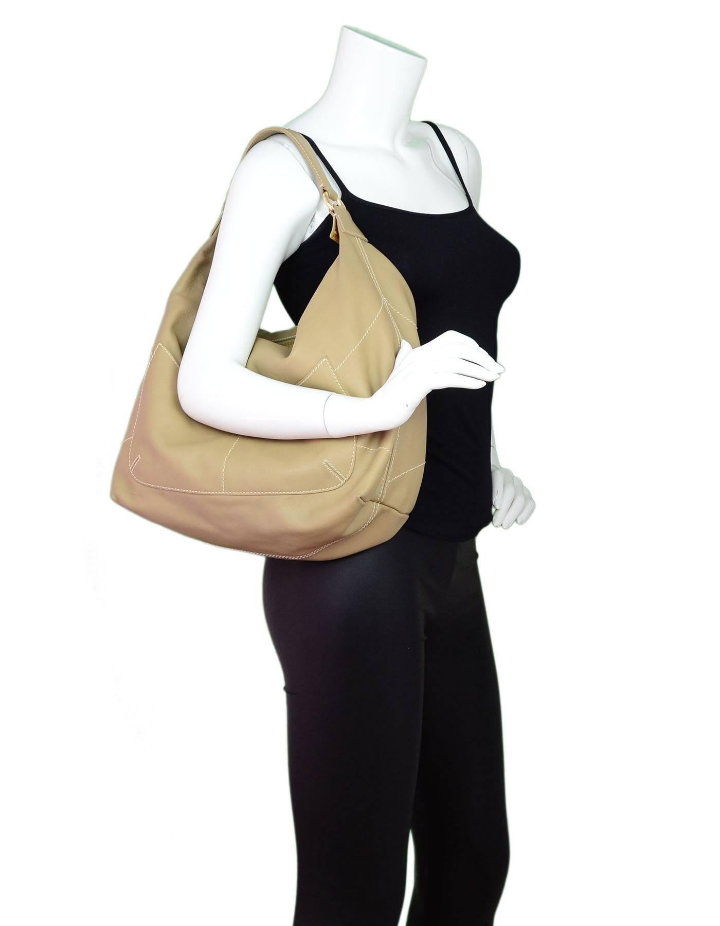Loro Piana Beige Leather Hobo Bag

Made In: Italy
Color: Beige
Hardware: Goldtone
Materials: Leather
Lining: Beige textile
Closure/Opening: Zip top
Exterior Pockets: Two patch pockets
Interior Pockets: One zip wall pocket
Overall Condition: