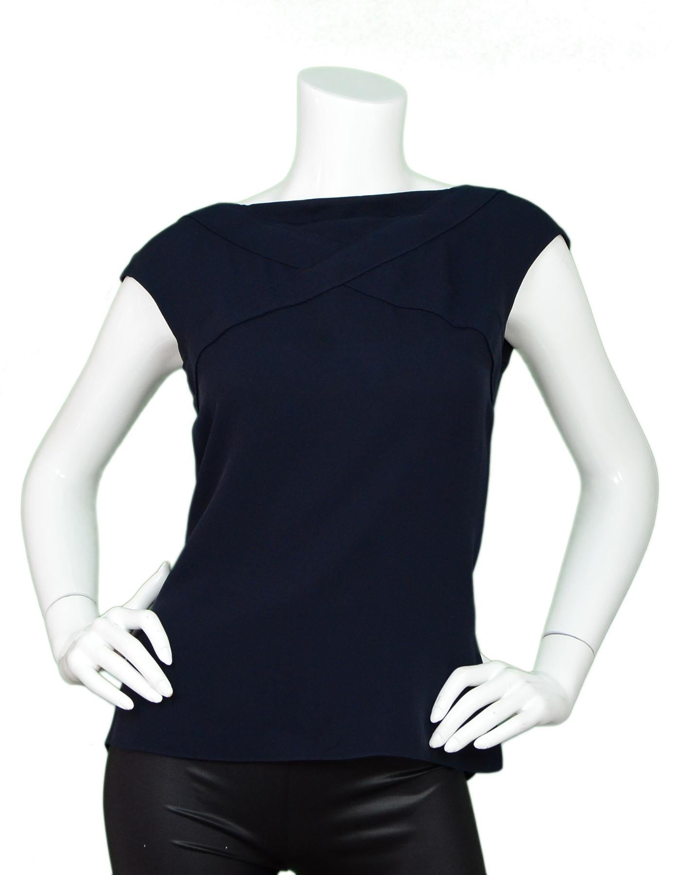 Chanel Navy Silk Top Sz FR38

Made In: France
Color: Navy
Composition: 100% silk
Lining: None
Closure/Opening: Button closure at back
Exterior Pockets: None
Interior Pockets: None
Overall Condition: Excellent pre-owned condition with the exception