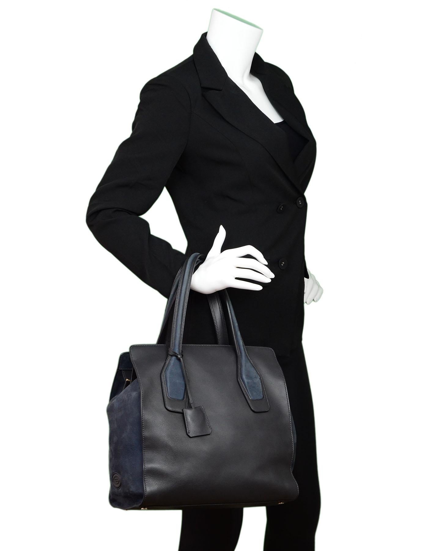 Tod's Black Leather & Navy Suede Tote

Made In: Italy
Color: Black, navy
Materials: Leather, suede
Lining: Black leather
Closure/Opening: Zip top
Exterior Pockets: None
Interior Pockets: One zip wall pocket
Overall Condition: Excellent pre-owned