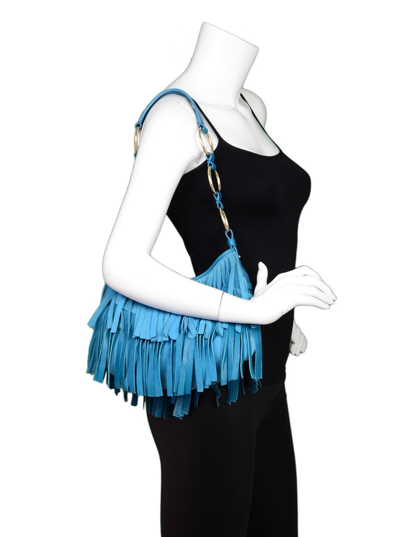 Yves Saint Laurent Aqua Suede & Leather Fringe Nadja Bag

Made In: Italy
Color: Aqua blue
Hardware: Goldtone
Materials: Leather, suede, metal
Lining: Black textile
Closure/Opening: Open top with center snap
Exterior Pockets: None
Interior Pockets: