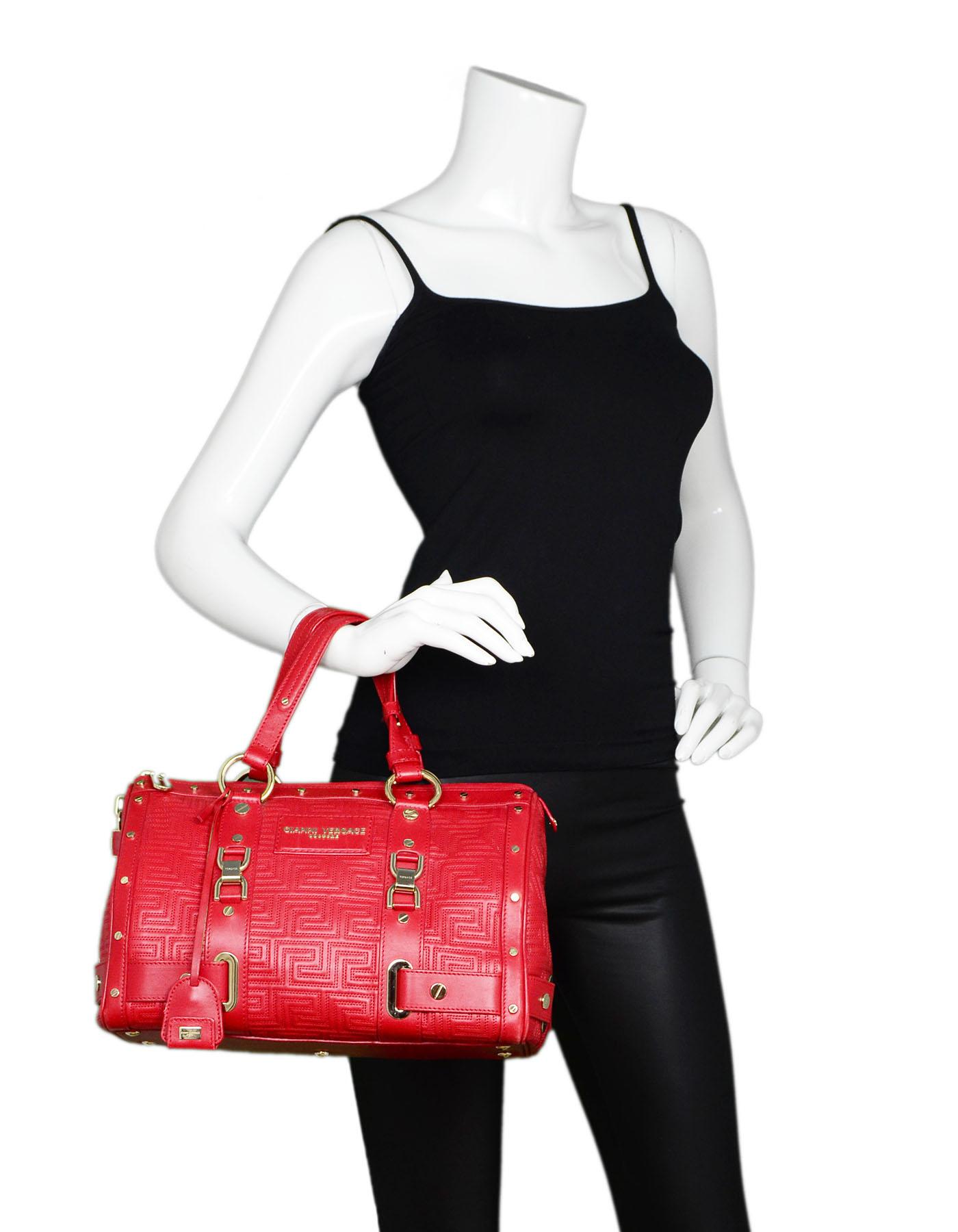 Versace Red Leather Boston Bag 

Made In: Italy
Color: Red, gold
Materials: Leather, metal
Lining: Cream textile
Closure/opening: Zip top closure
Exterior Pockets: None
Interior Pockets: Zip wall pocket, patch pocket
Overall Condition: Excellent