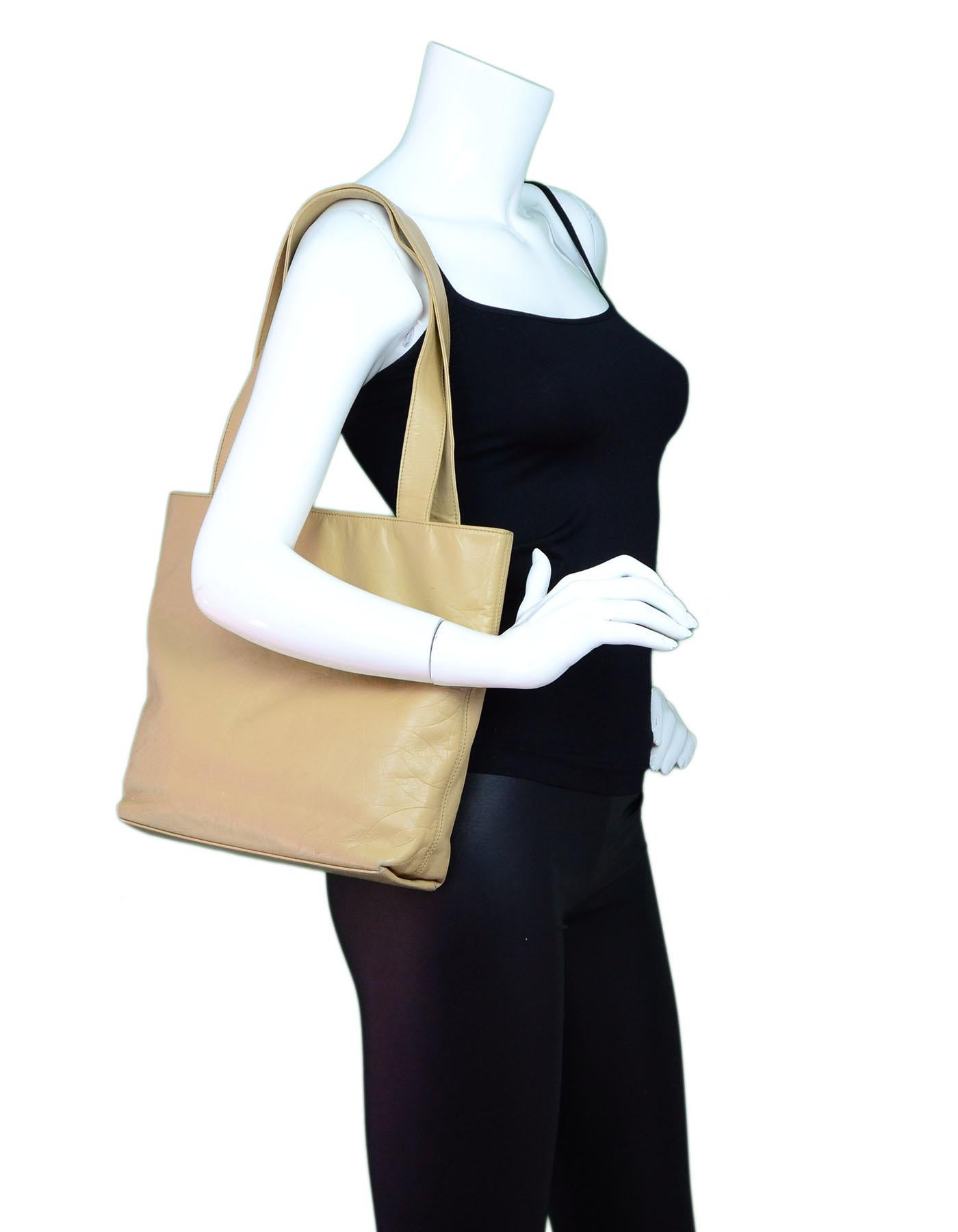Chanel Beige Leather CC Embossed Tote

Made In: Italy
Year of Production: 2000-2002
Color: Beige
Hardware: Goldtone
Materials: Leathr
Lining: Beige grossgrain
Closure/Opening: Open top with center magneitc snap
Exterior Pockets: None
Interior