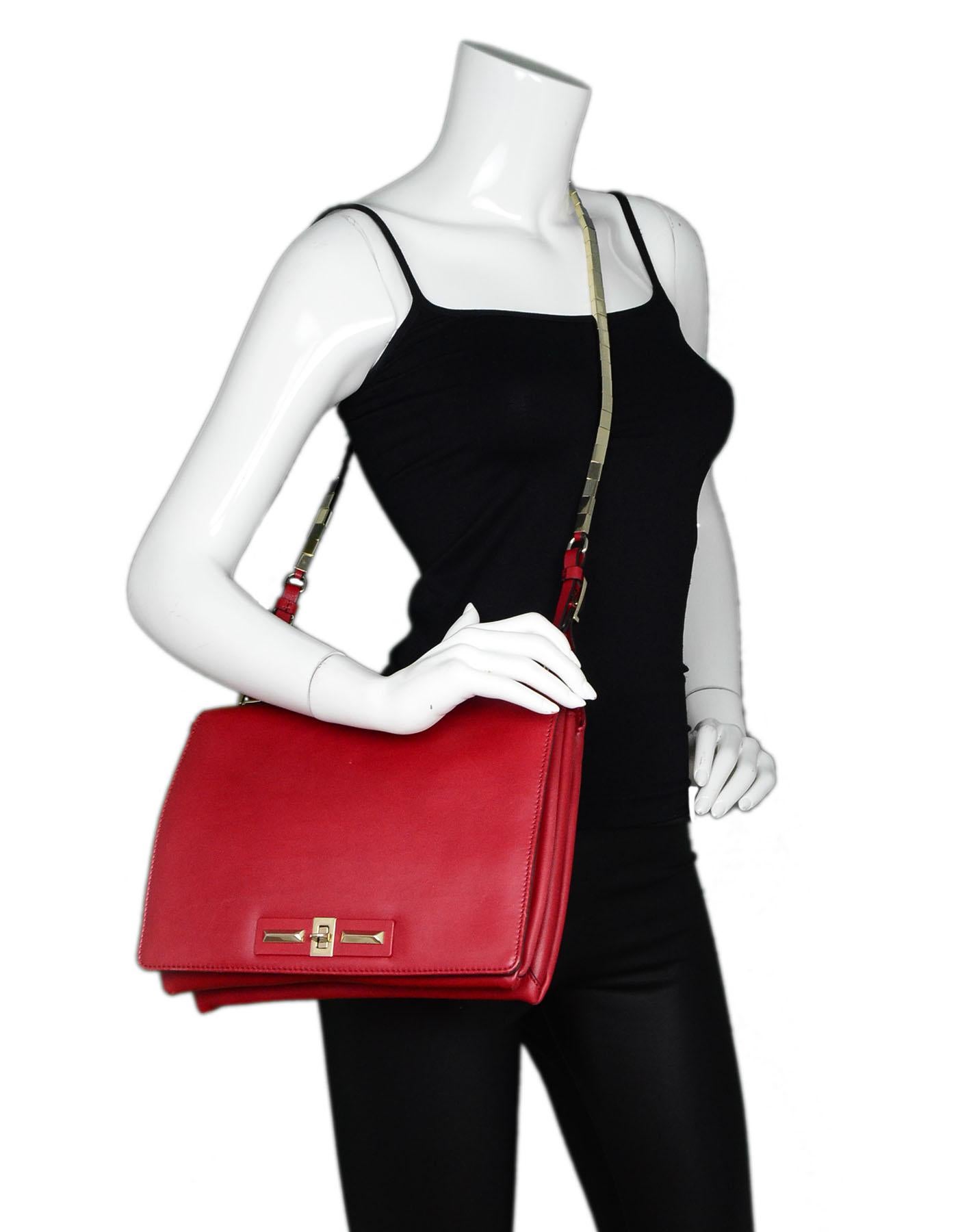 Valentino Red Leather Crossbody Bag

Made In: Italy
Color: Red
Hardware: Goldtone
Materials: Leather, metal
Lining: Beige leather
Closure/Opening: Flap with twist lock closure
Exterior Pockets: None
Interior Pockets: Two compartments - one