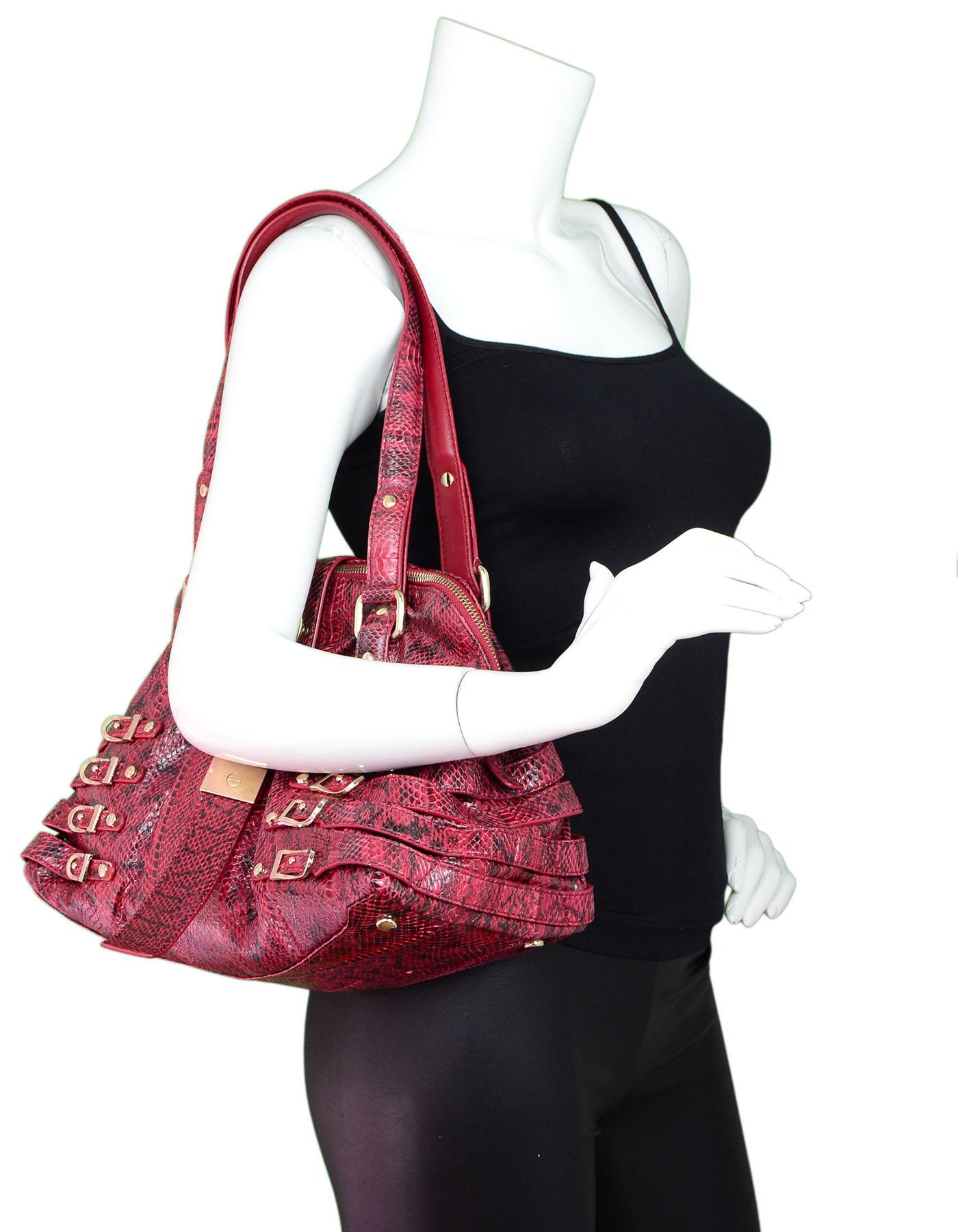 Jimmy Choo Red Snakskin Buckle Bag

Made In: Italy
Color: Red
Hardware: Goldtone
Materials: Snakeskin, metal
Lining: Beige textile
Closure/Opening: Double zip top
Exterior Pockets: None
Interior Pockets: Zip wall pocket, wall pocket
Overall