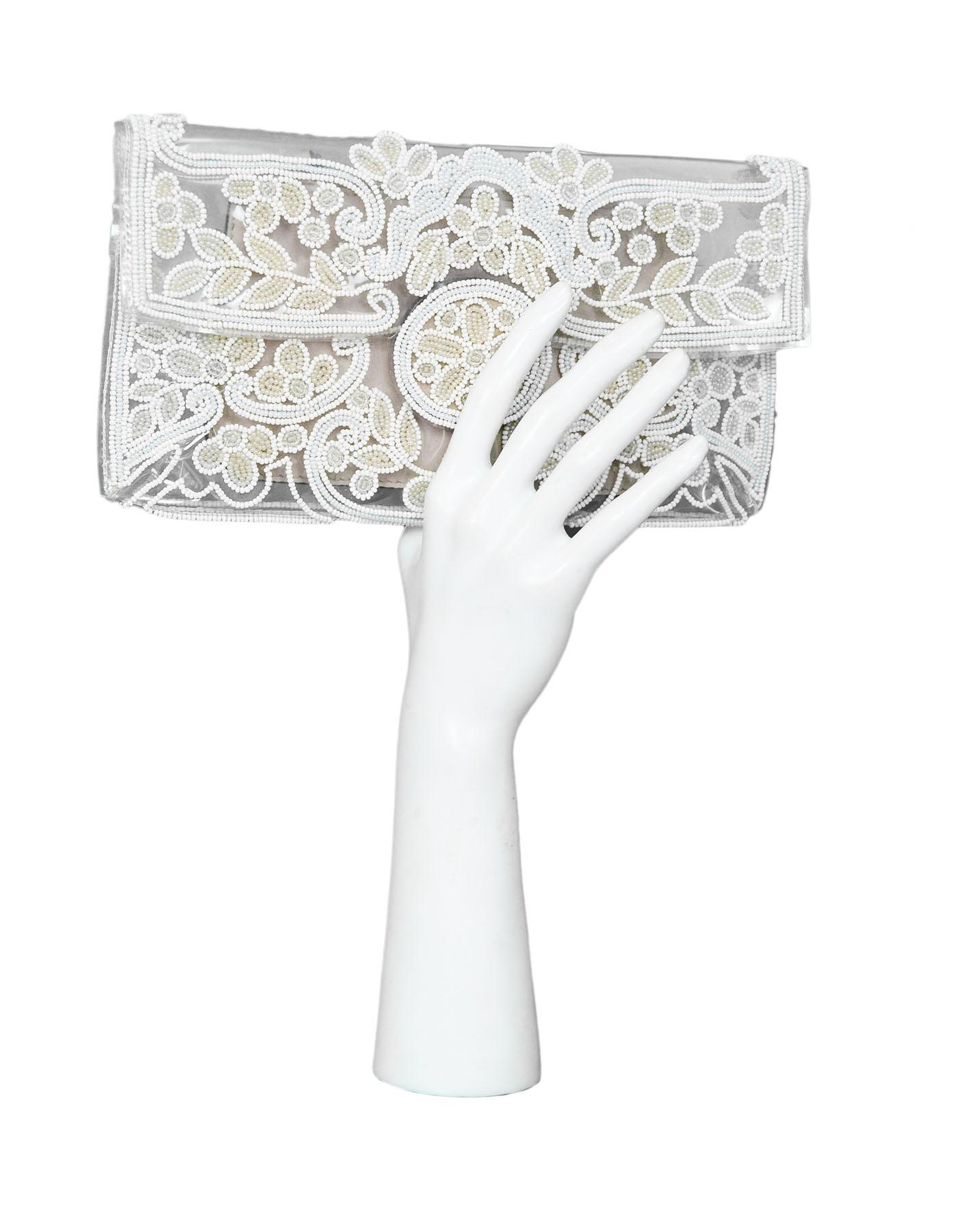 Valentino Clear PVC & White Beaded Clutch
Features small zip insert

Made In: Italy
Color: Clear, white
Hardware: Goldtone
Materials: PVC, beads, leather
Lining: None
Closure/Opening: Flap with snap closure
Exterior Pockets: None
Interior Pockets: