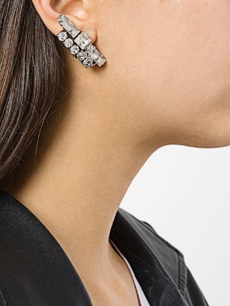 Saint Laurent Silvertone Crystal Smoking Set of 3 Clip Earrings
Features three earrings with multi-faceted baguette, round and square hand-set crystals and a clip on fastening. YSL metal logo soldered on the two larger earrings.

Made In:
