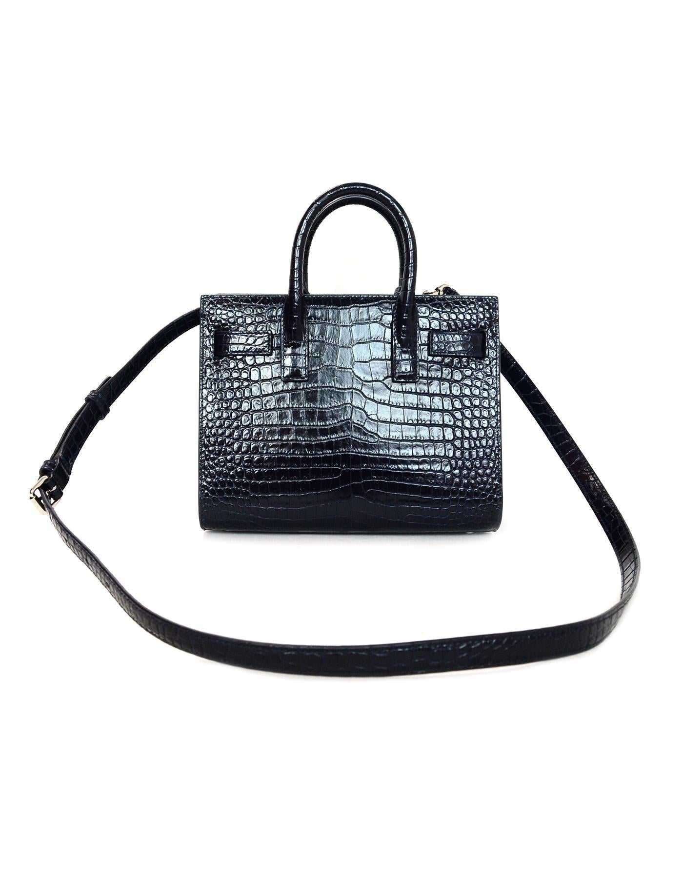 Saint Laurent Midnight Blue Nano Sac De Jour
Features embossed glazed leather to create a crocodile skin effect throughout. Detachable shoulder/crossbody strap

Made In: Italy
Color: Midnight blue- very dark blue, close to black in