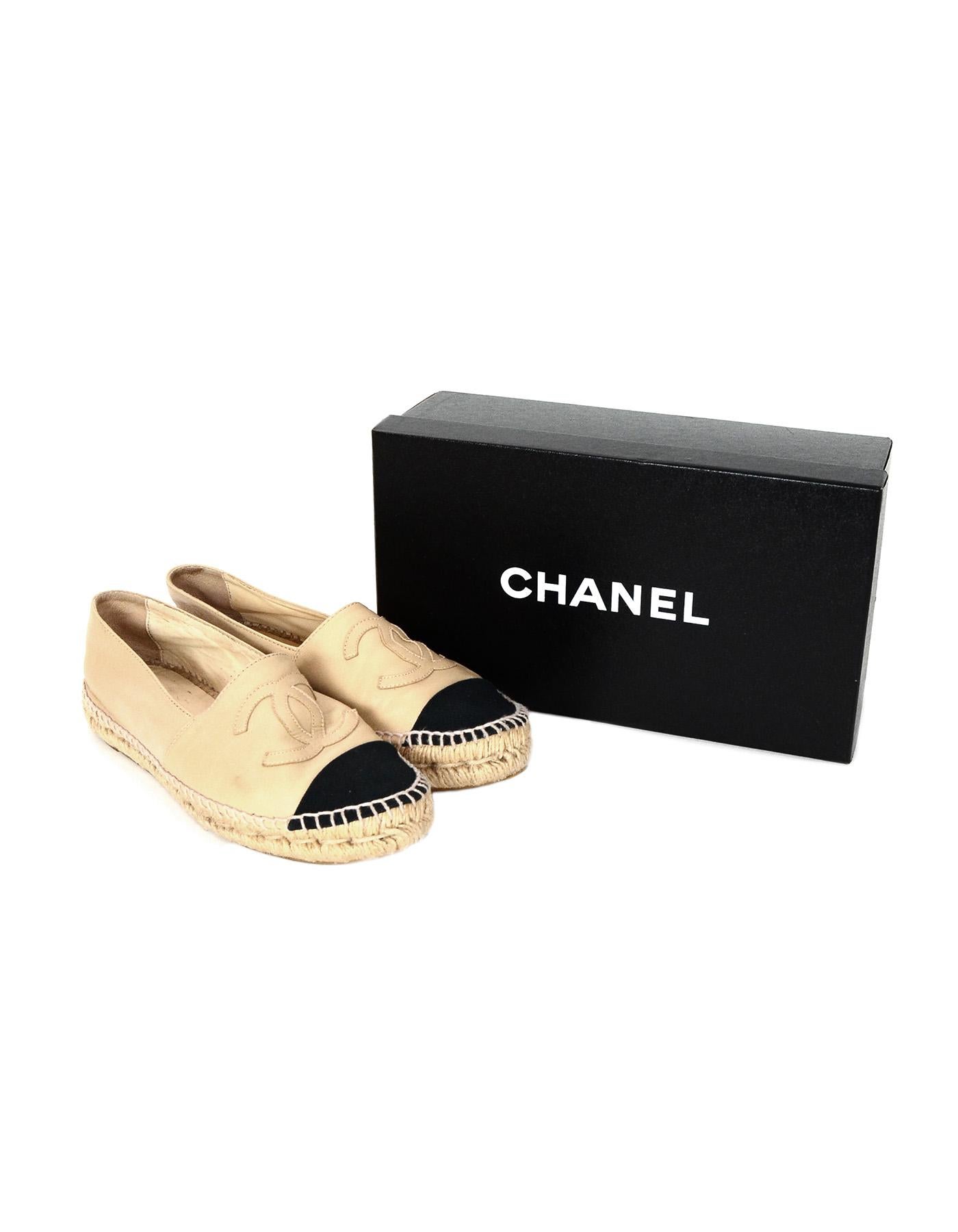 Chanel Tan/Black Leather/Canvas Espadrille Cap Toe Shoes Sz 38

Made In: Spain
Color: Tan and black
Materials: Leather and canvas
Closure/Opening: Slide on
Overall Condition: Very good pre-owned condition with exception of some markings in leather