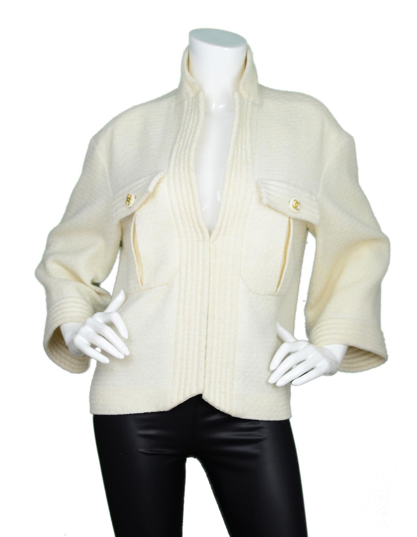 Chanel Cream Glitter Open Tweed Jacket W/ Ribbed Trim And CC Buttons Sz 42

Made In: France
Color: Cream and gold
Materials: 89% wool, 11% nylon
Lining: 100% silk
Opening/Closure: Open front
Overall Condition: Very good pre-owned condition with