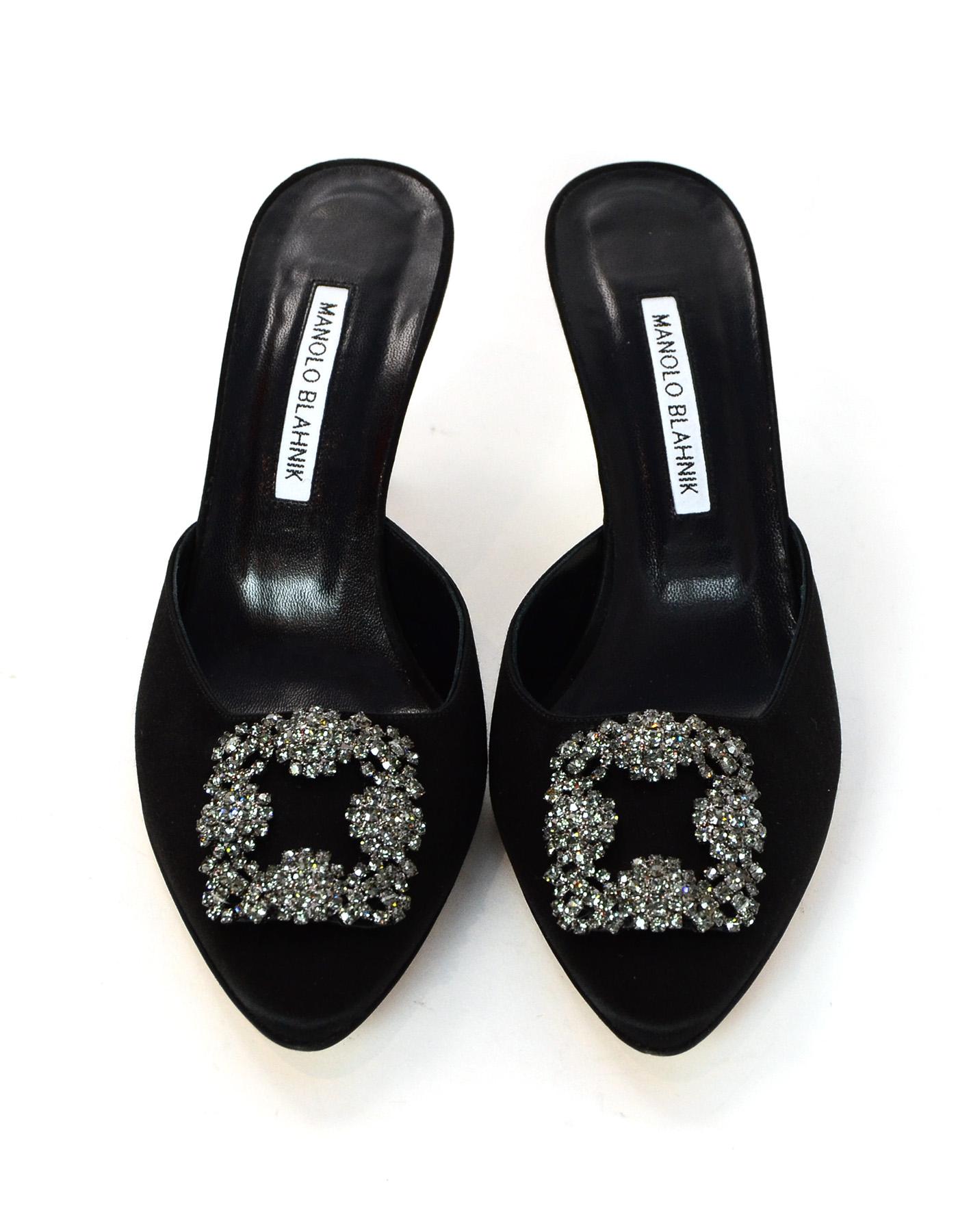 Manolo Blahnik, 2018, Black Satin/Crystal Hangisi 70 Heeled Mules Sz 39

Made In: Italy
Year of Production: 2018
Color: Black and crystal
Materials: Satin and crystal
Closure/Opening: Slide on mules
Overall Condition: Excellent pre-owned condition-
