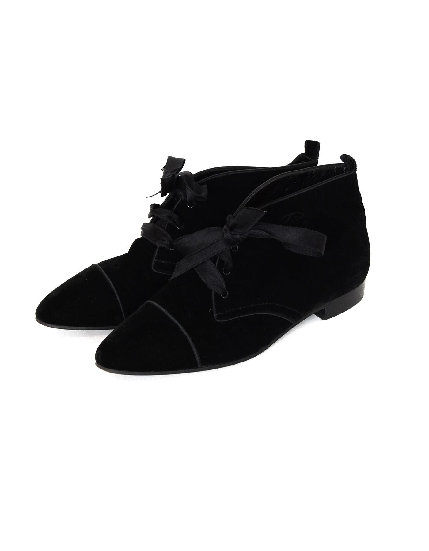 Chanel Black Velvet Lace Up Ankle Booties With Embroidered CC On The Side Sz 40.5

Made In: Italy
Color: Black
Materials: Velvet
Closure/Opening: Lace up
Overall Condition: Excellent pre-owned condition, minimal wear on soles and in