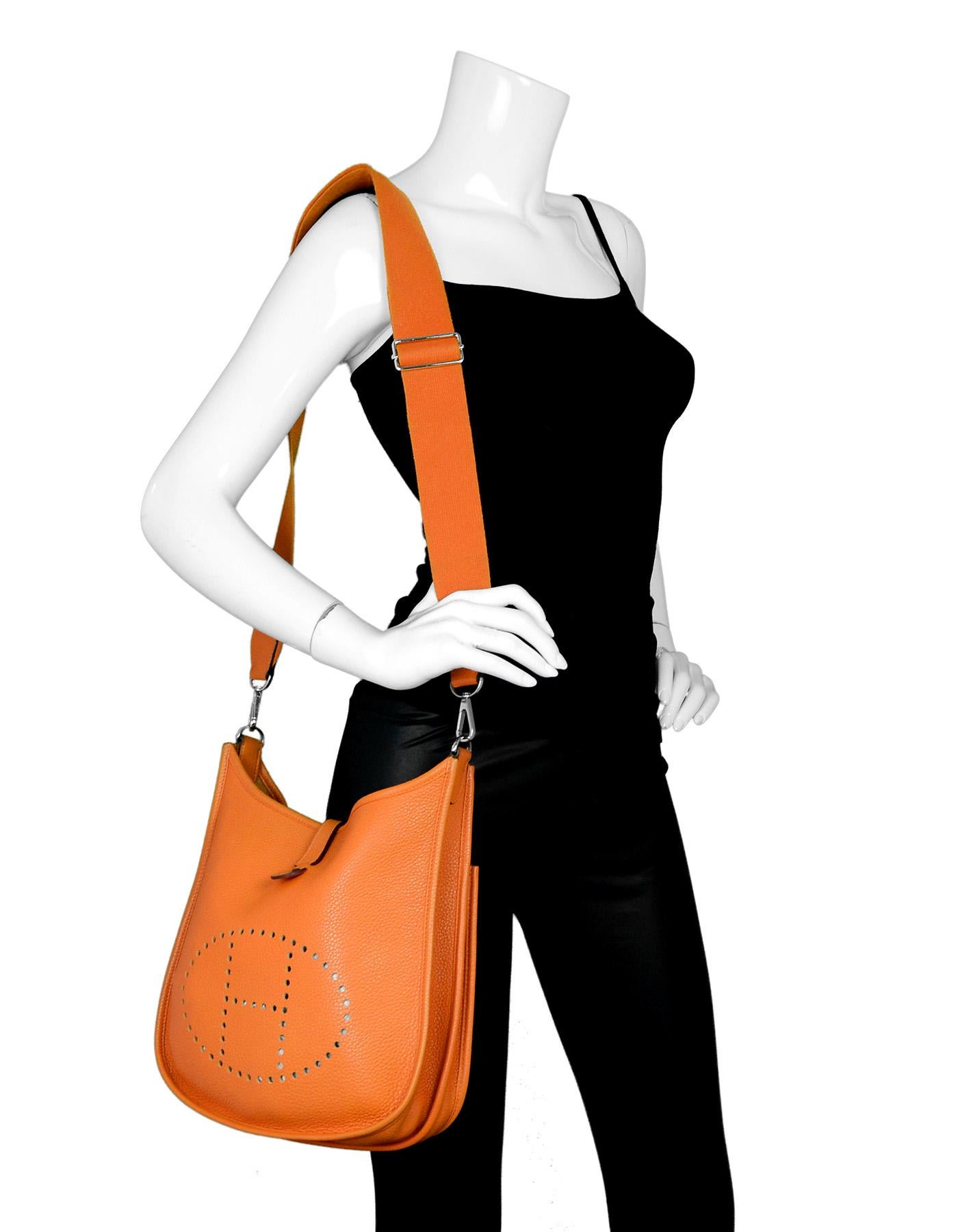 Hermes Orange Clemence Leather Evelyne III PM Messenger Crossbody Bag With Perforated H Icon In Circle On Front

Made In: France
Year Of Production: 2011
Color: Orange
Hardware: Palladium 
Materials: Clemence leather 
Lining: Orange