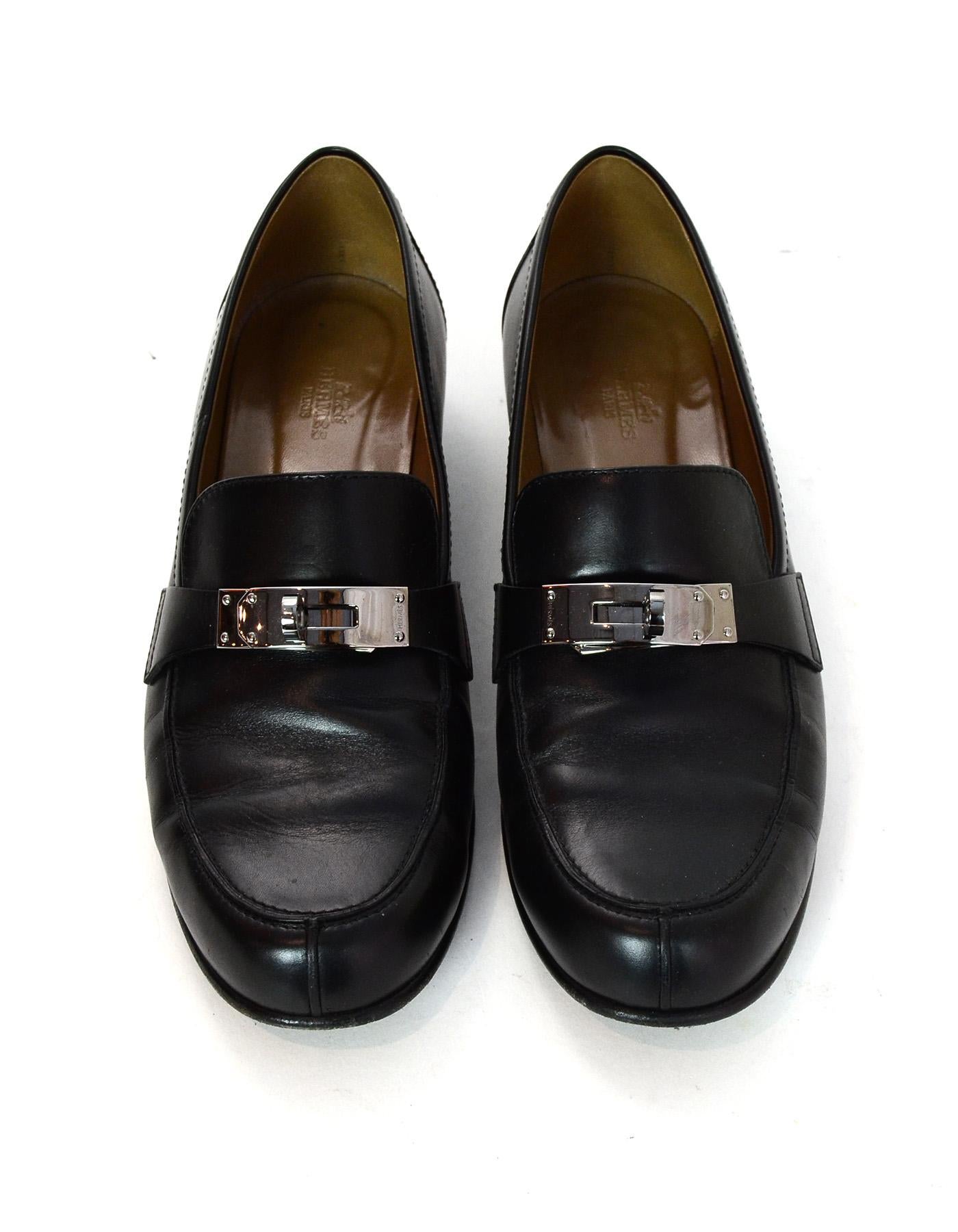 Hermes Black Leather Palladium Jule Heeled Loafers W/ Kelly Buckle Sz 40

Made In: Italy
Color: Black
Hardware: Palladium
Materials: Leather and palladium metal 
Closure/Opening: Slide on
Overall Condition: Excellent pre-owned condition with