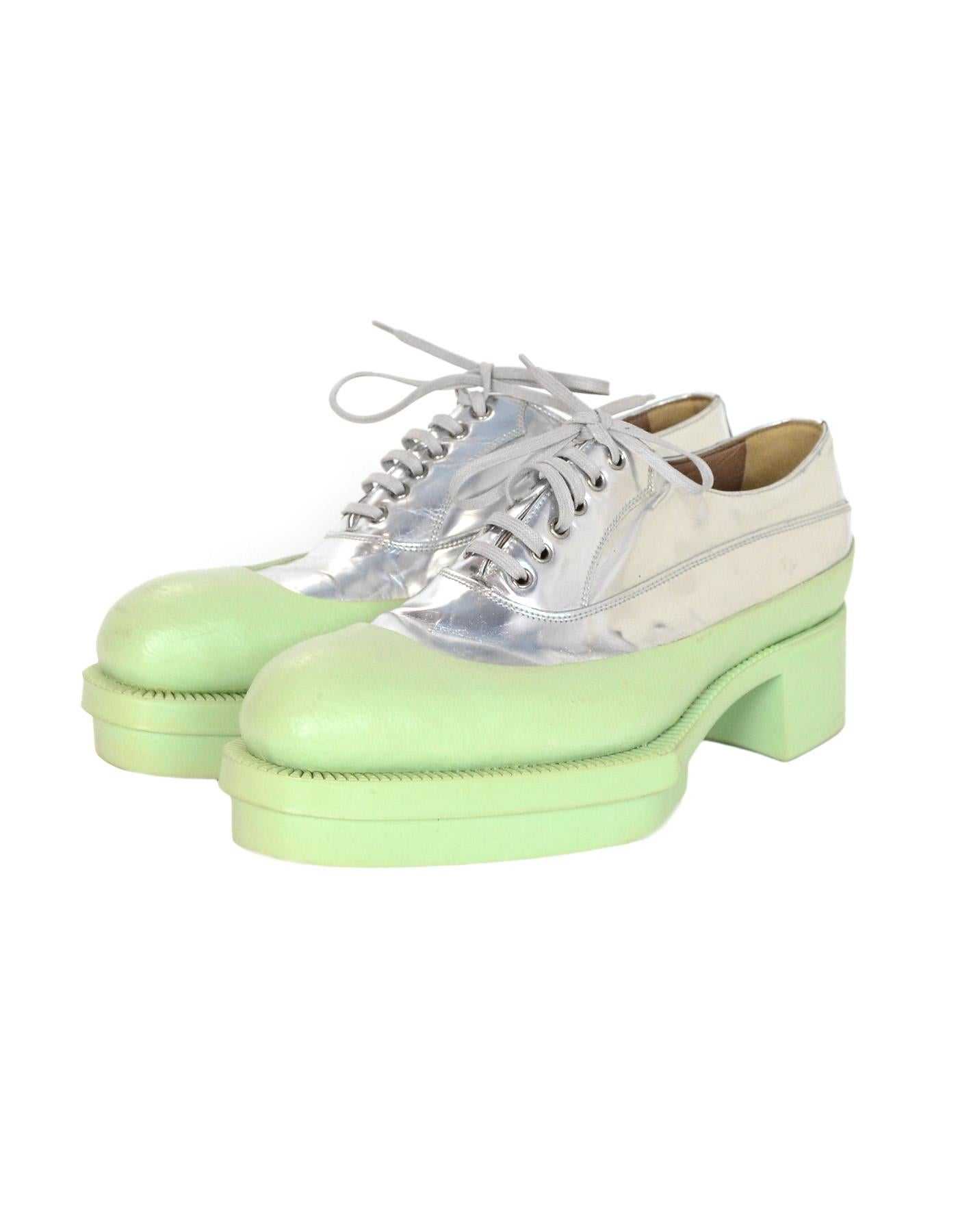 Prada Mint Green Metallic Silver Rubber & Leather Heeled Platform Lace Up Oxfords Sz 38.5

Made In: Italy
Color: Mint green and metallic silver
Hardware: Silvertone
Materials: Rubber and leather 
Closure/Opening: Lace up
Overall Condition: Excellent