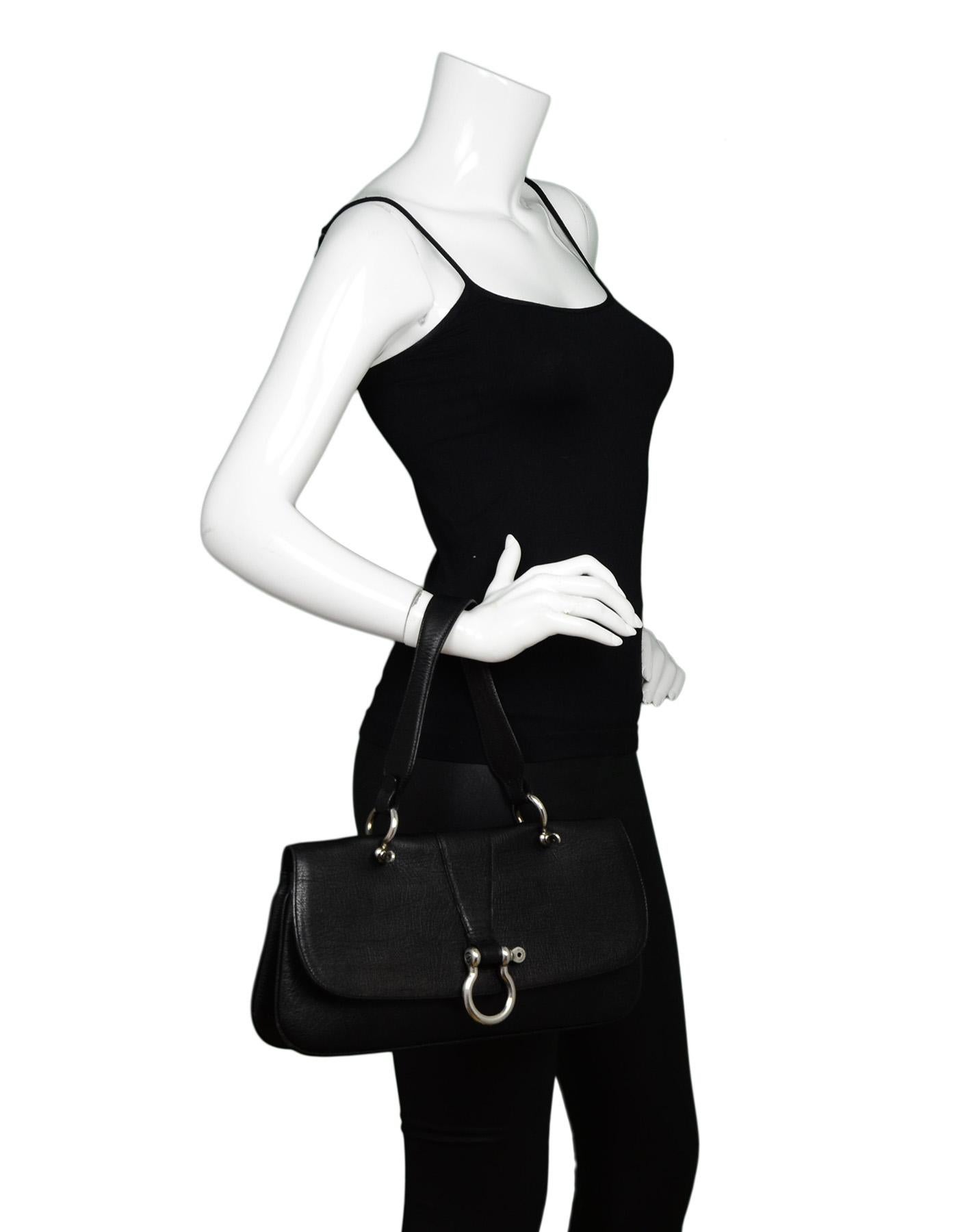 Burberry Black Leather Top Handle Flap Bag W/ Silver Ring Snap Flap Closure 

Made In: Italy
Color: Black
Hardware: Silvertone
Materials: Leather
Lining: Cream textile 
Closure/Opening: Flap top with snap closure
Exterior Pockets: None
Interior