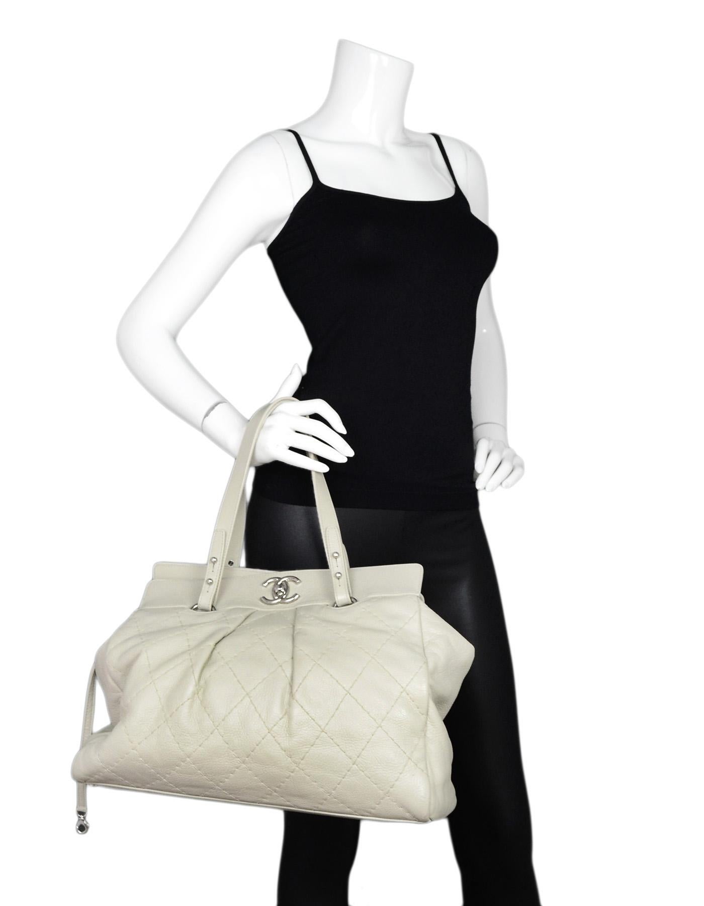 Chanel Ivory Quilted Leather CC Twist Lock Tote Bag

Made In: Italy
Year of Production: 2006
Color: Ivory
Hardware: Silvertone
Materials: Leather and metal
Lining: White textile
Closure/Opening: CC twist lock
Exterior Pockets: None
Interior Pockets: