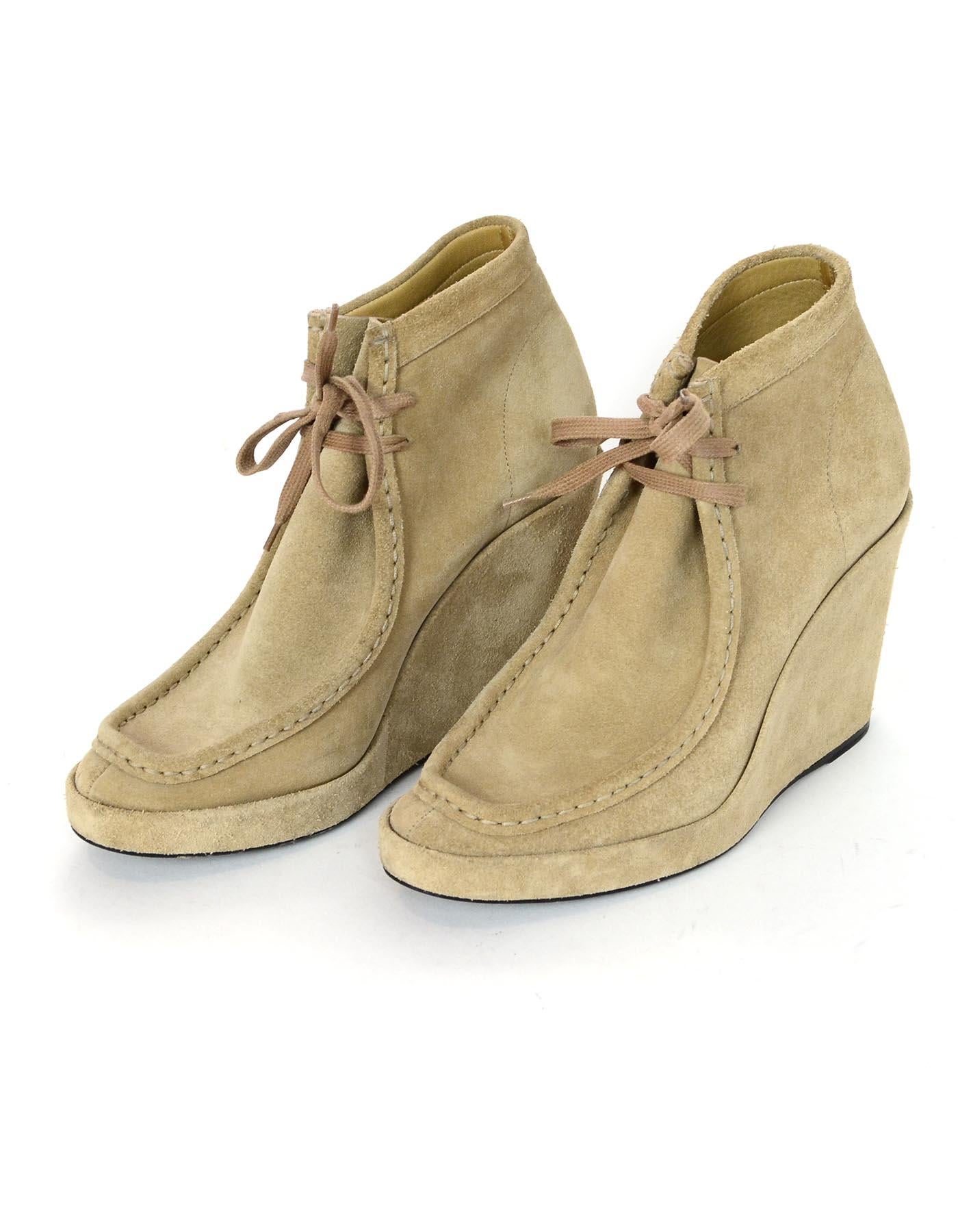 Balenciaga Tan Suede Wedge Lace Front Ankle Boots Sz 39

Made In: Italy
Color: Tan
Materials: Suede
Closure/Opening: Lace up front
Overall Condition: Excellent pre-owned condition with exception of minor scuffing on back of heel and sides 