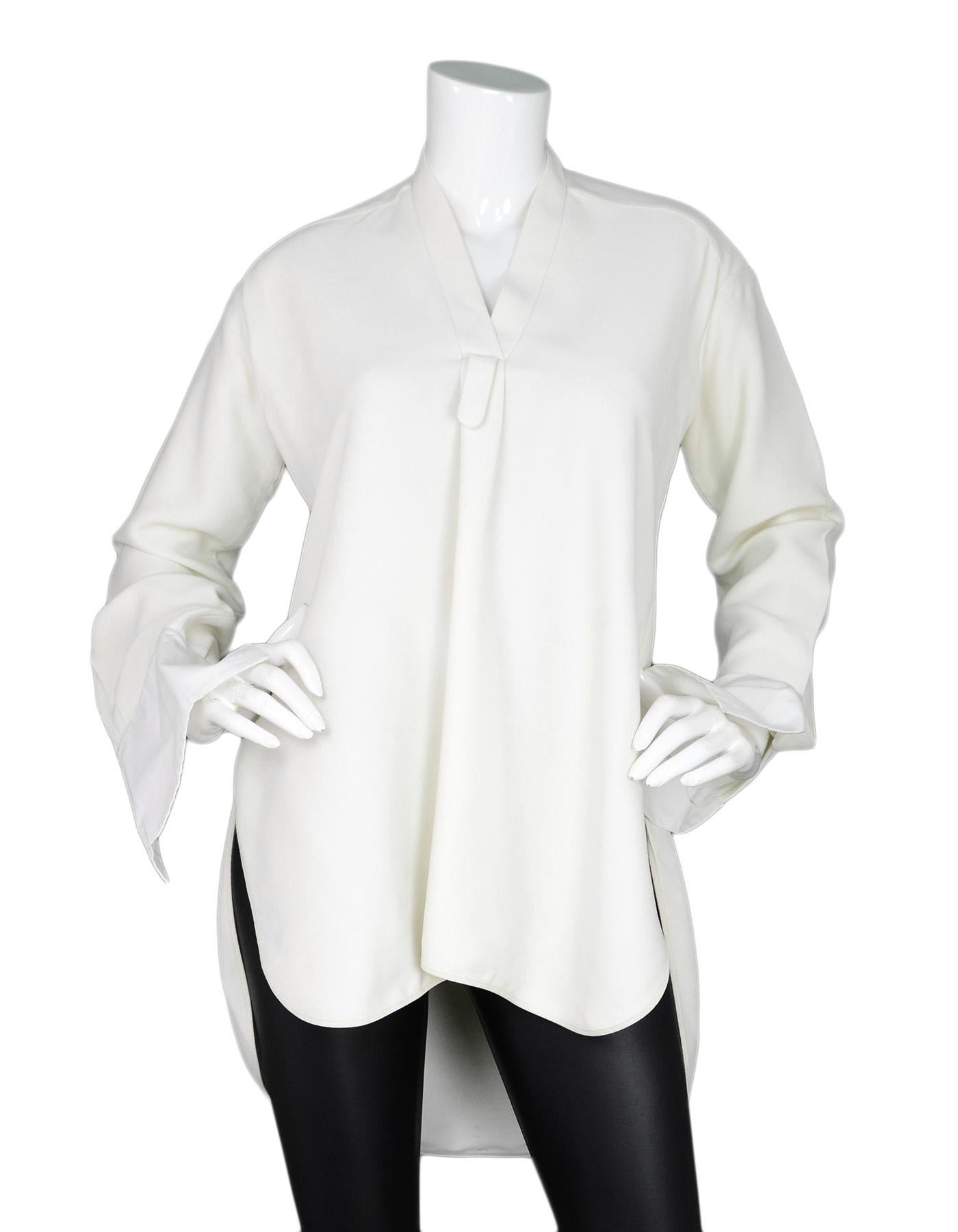 Celine Cream Longsleeve Tunic W/ V Cut Sz 34

Made In:  France
Color: Cream
Materials: Viscose and silk, composition tag is faded and hard to read percentages
Opening/Closure: Pull over 
Overall Condition: Very good pre-owned condition with minor