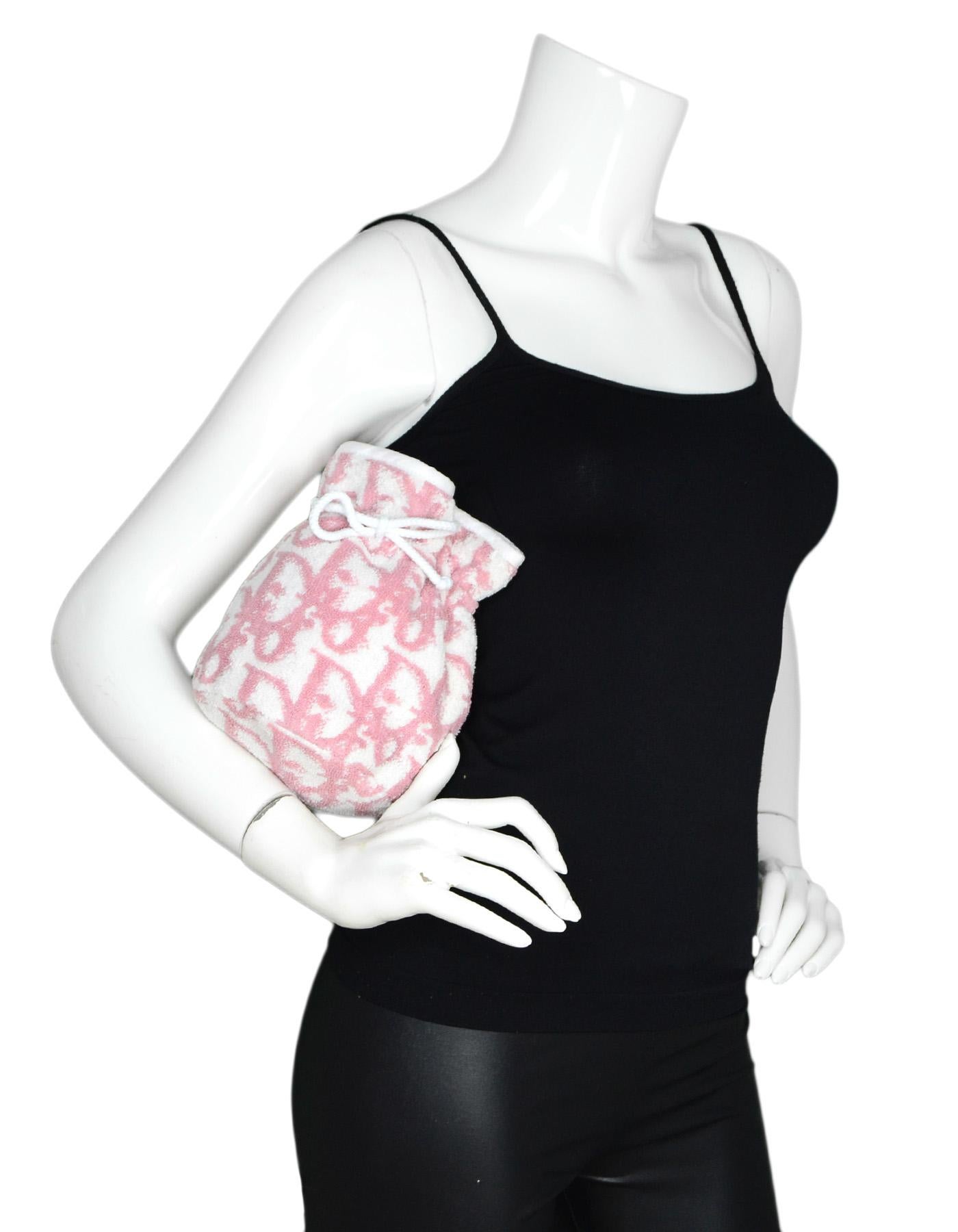 Christian Dior Vintage Pink/White Monogram Cotton Terrycloth Drawstring Cosmetic Bag/Pouch

Color: Pink/white
Materials: 100% cotton terrycloth 
Lining: White plastic 
Closure/Opening: Drawstring top
Exterior Pockets: None
Interior Pockets: