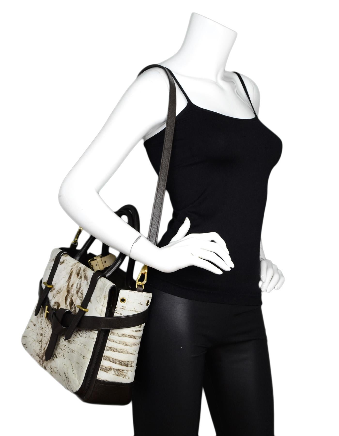 Reed Krakoff Brown Leather Pony Hair Animal Print Boxer Tote Bag W/ Strap

Made In: China
Color: Brown/white animal print
Hardware: Goldtone
Materials: Leather and pony hair
Lining: Black textile
Closure/Opening: Open top
Exterior Pockets: One rear