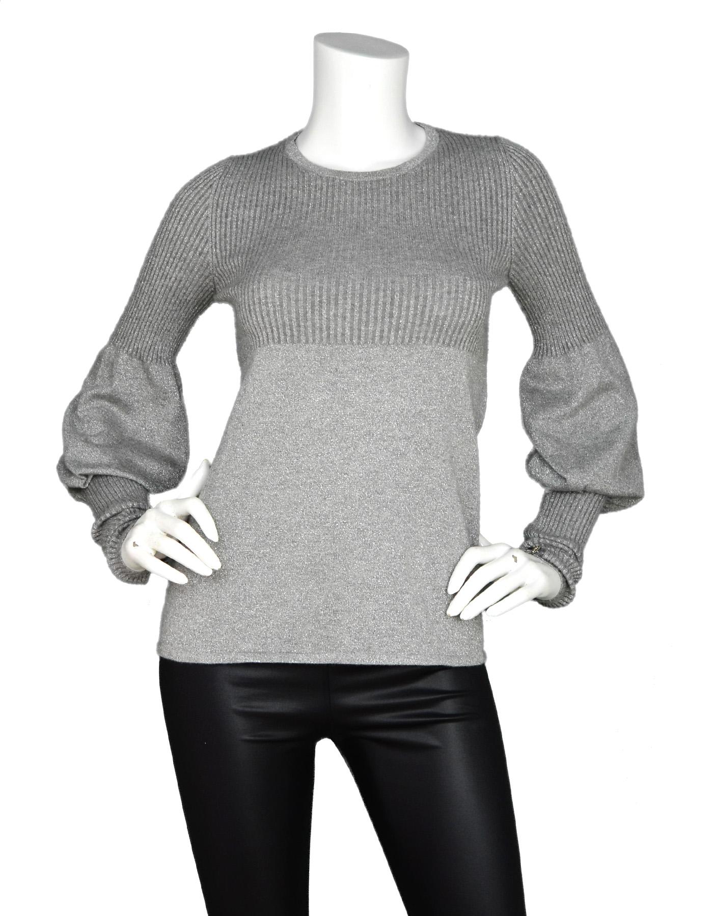 Chanel Grey Cashmere/Cotton Glitter Long Balloon Sleeve Sweater W/ Crystal CC Buttons On Sleeves Sz 36

Made In: Italy
Year Of Production: 2005
Color: Grey
Materials: 60% cashmere, 13% cotton, 7% metalized polyester 
Opening/Closure: Pull