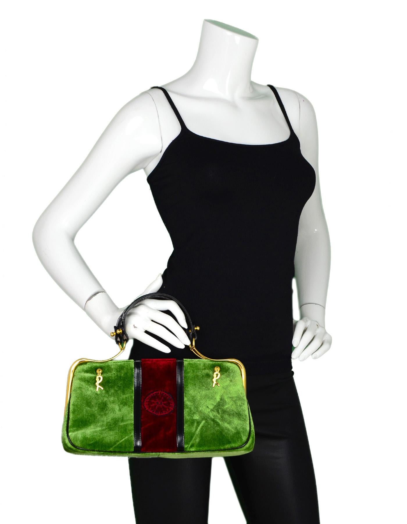 Roberta Di Camerino Vintage Green/Red Velvet Top Handle Bag

Made In: Italy
Color: Green and red
Hardware: Goldtone
Materials: Velvet, patent leather and metal 
Lining: Black leather 
Closure/Opening: Metal hinge closure 
Exterior Pockets: