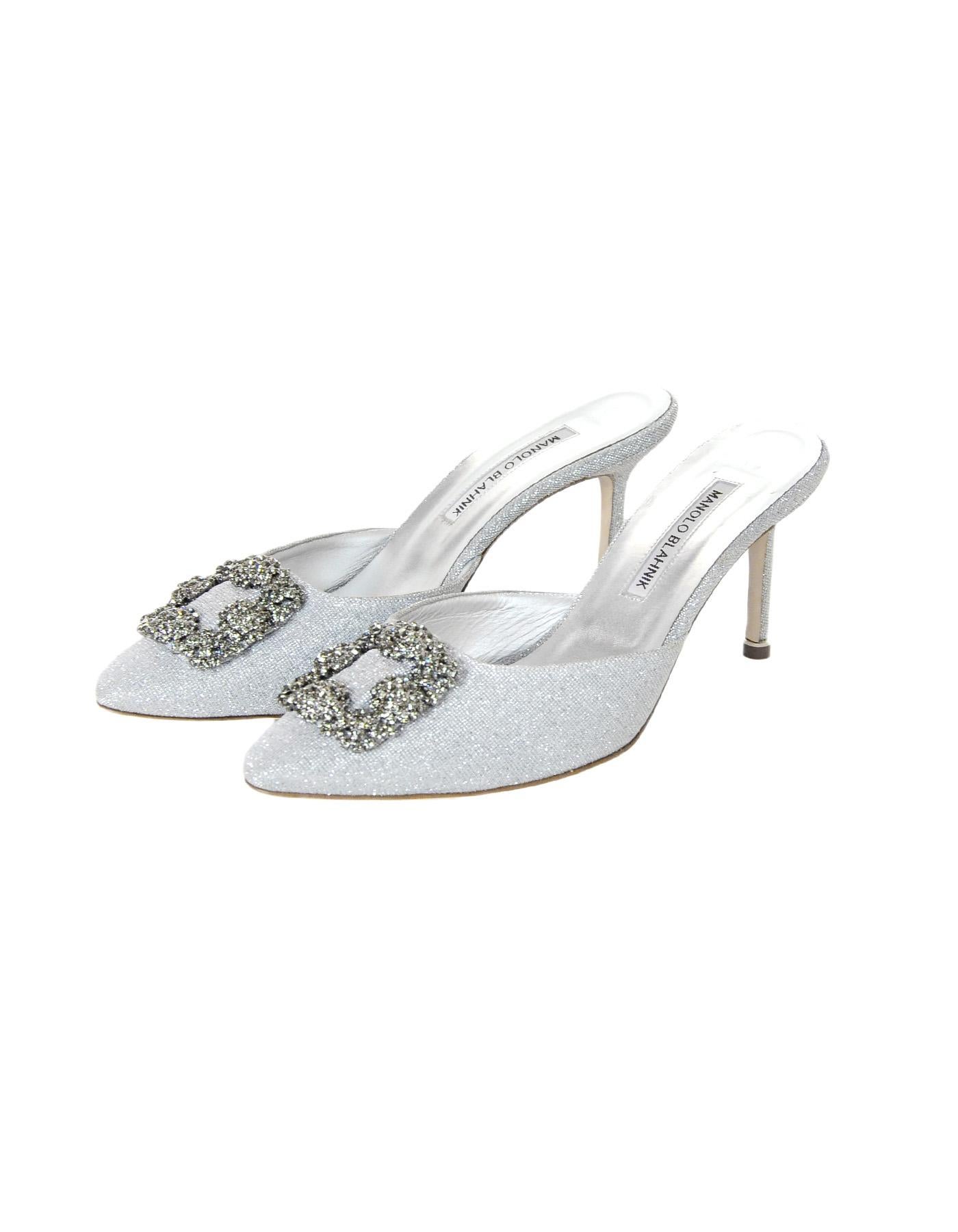 Manolo Blahnik Silver Metallic Hangisi Mule Heels Sz 39.5

Made In: Italy
Color: Silver
Hardware: Silvertone and crystals
Materials: Leather, fabric, crystals  
Closure/Opening:  Slide on
Overall Condition: Like new condition 
Estimated Retail: $985