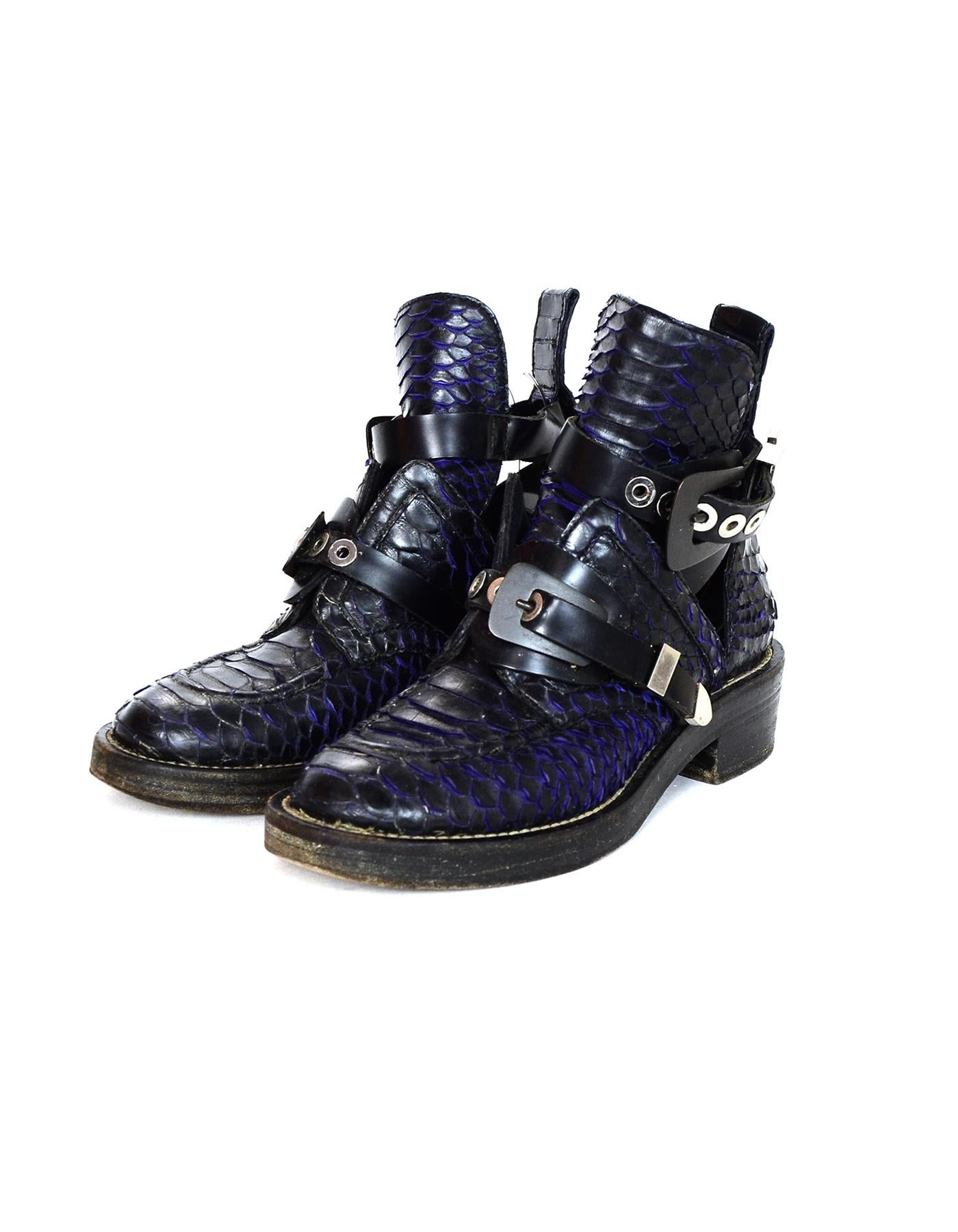Balenciaga Black/Purple Python Buckle Strap Short Ankle Boots Sz 39

Made In: Italy
Color: Black/purple
Hardware: Silvertone
Materials: Python, leather, and metal
Closure/Opening: One front and one side buckle
Overall Condition: Very good pre-owned