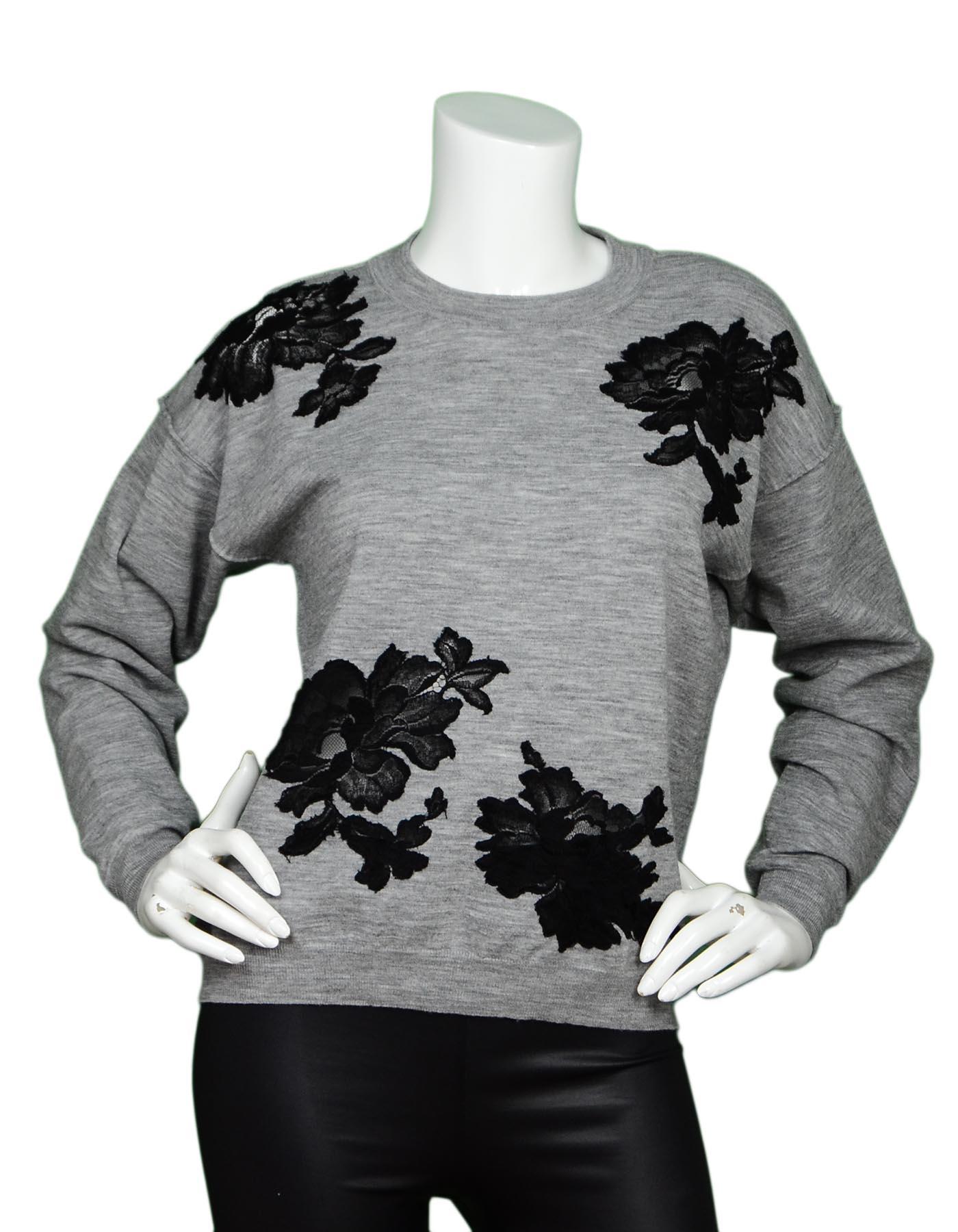 Lanvin Grey Sweater W/ Black Lace Flowers Sz M

Made In: Italy
Color: Grey
Materials: 87% wool, 13% polyester, lace- 82% cotton, 18% nylon
Opening/Closure: Pull over
Overall Condition: Excellent pre-owned condition, with exception of missing size
