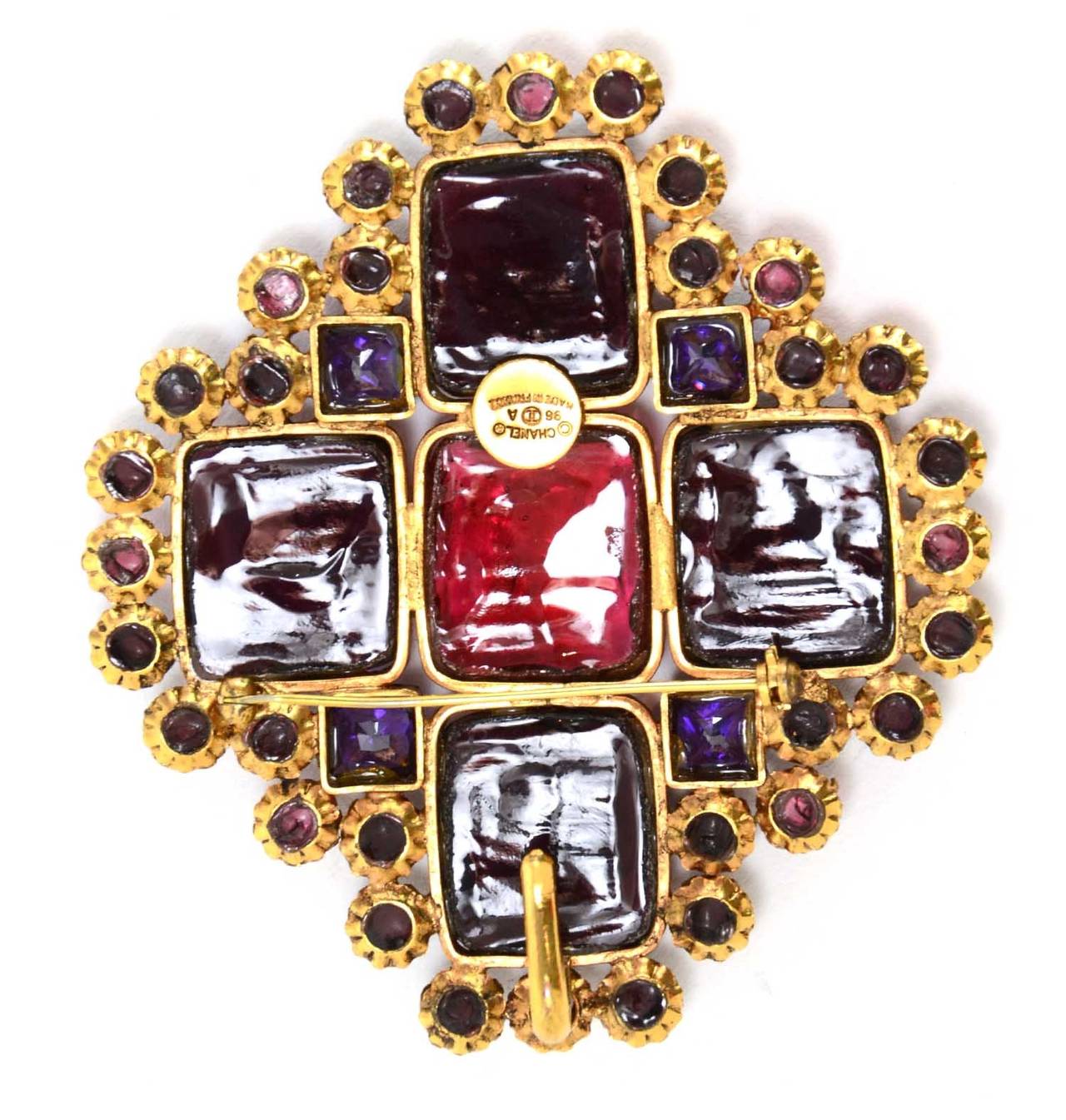 Chanel Vintage '96 Red & Purple Gripoix Brooch

    Made in: France
    Year of Production: 1996
    Stamp: 96 CC A
    Closure: Pin back closure
    Color: Brass, red and purple
    Materials: Metal and poured glass
    Overall Condition: