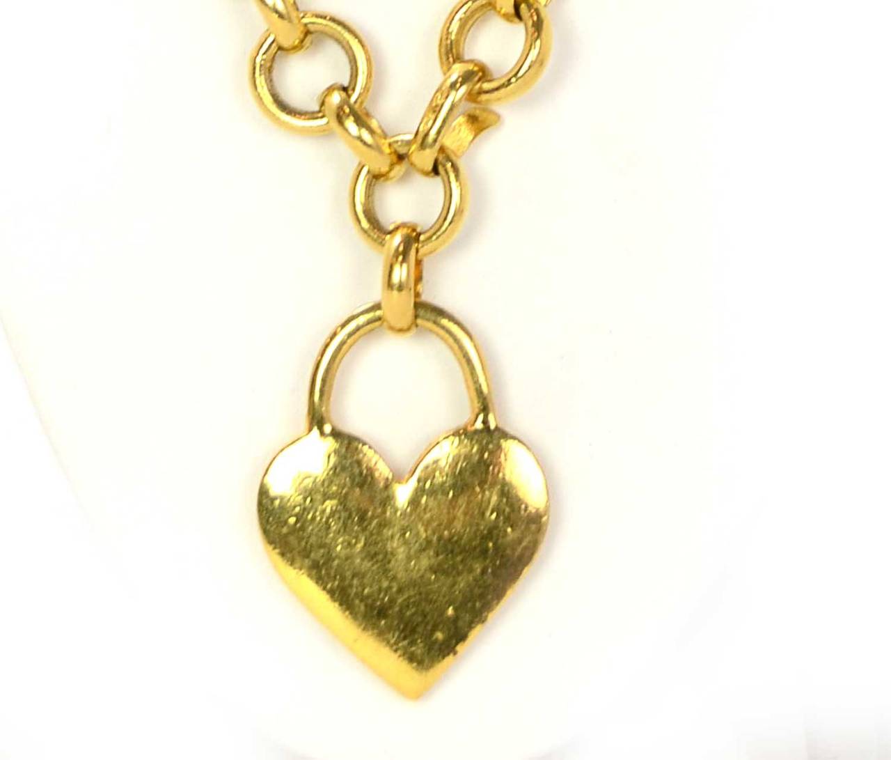 CHANEL Gold Chain & Heart Necklace w/Red StoneFeatures red stone at the center of gold heart pendant

    Made in: Not given- believed to be France
    Stamp: CHANEL
    Closure: Jump ring closure
    Color: Gold and red
    Materials: Metal
