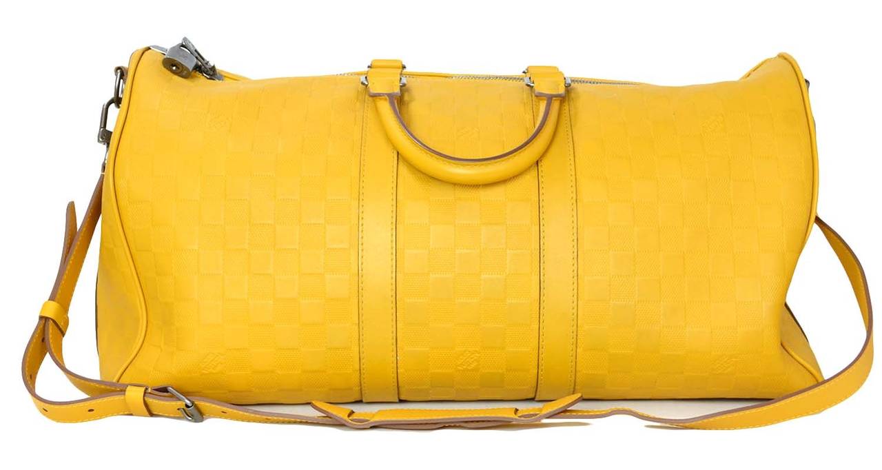 Louis Vuitton '12 Mustard Damier Infini 45 cm Keepall BandouliereFeatures adjustable & detachable shoulder strap

    Made in: France
    Year of Production: 2012
    Color: Mustard yellow
    Hardware: Satin-finished titanium
    Materials: