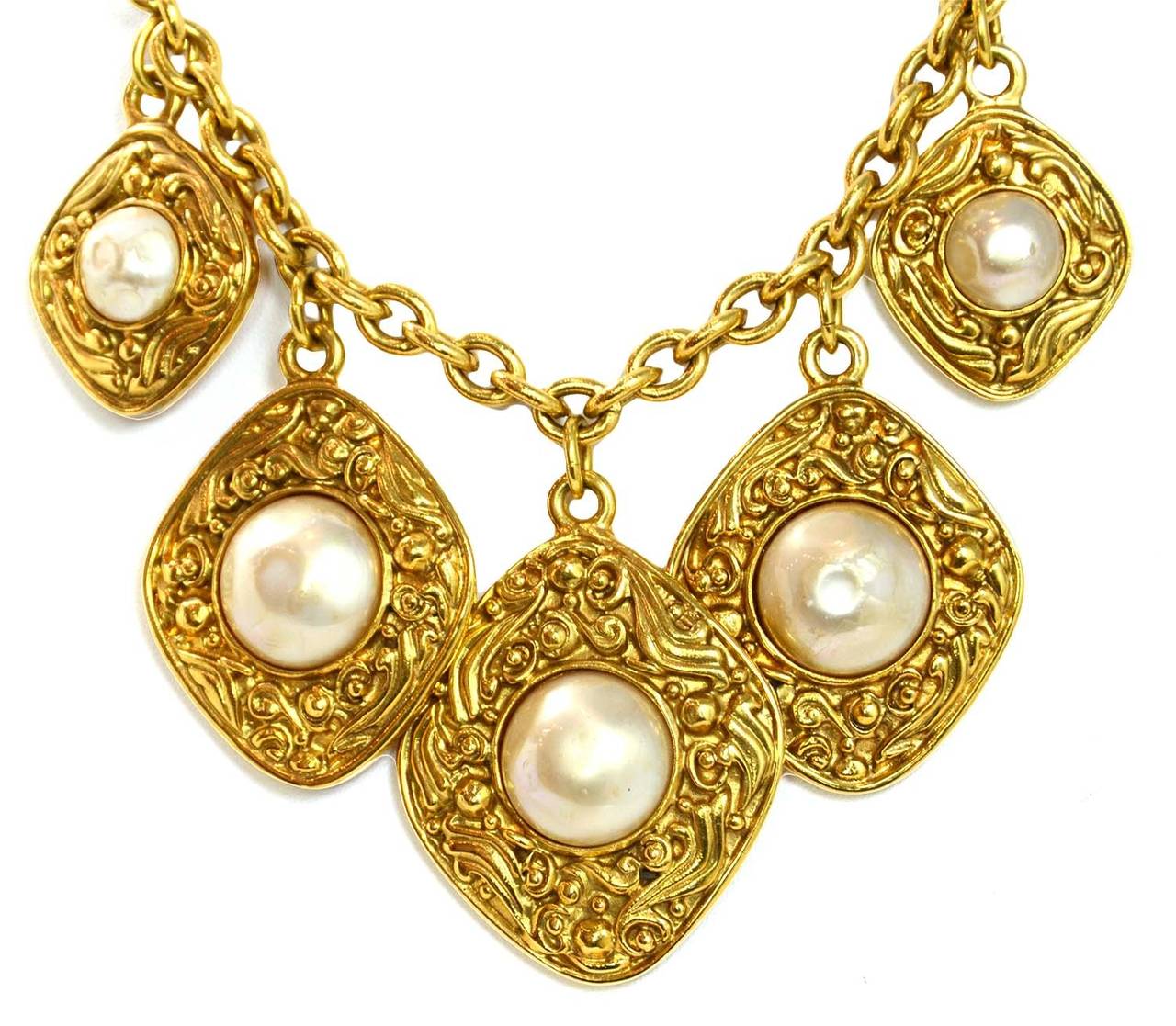 Chanel Vintage 90's Gold Necklace w/5 Hanging Gold & Pearl PendantsFeatures intricate detailing to goldtone diamond pendants

    Made in: France
    Year of Production: 1990's
    Stamp: CHANEL CC MADE IN FRANCE
    Closure: Jump ring