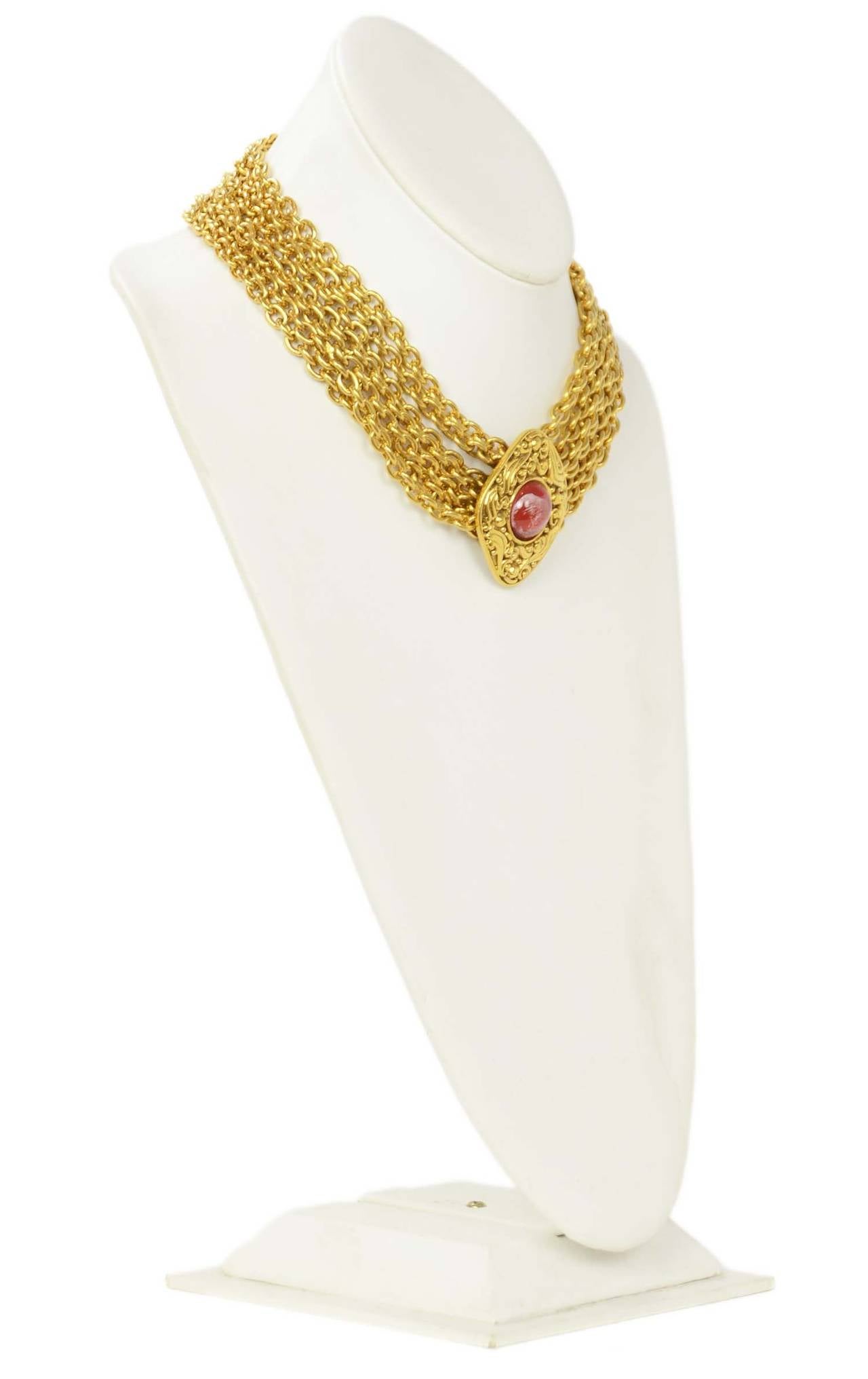 Chanel Vintage Gold and Red Gripoix Choker Necklace
Features red gripoix and gold pendant detail at back closure
    Made in: France
    Stamp: CHANEL CC MADE IN FRANCE
    Closure: Hook and eye closure
    Color: Goldtone and red
   