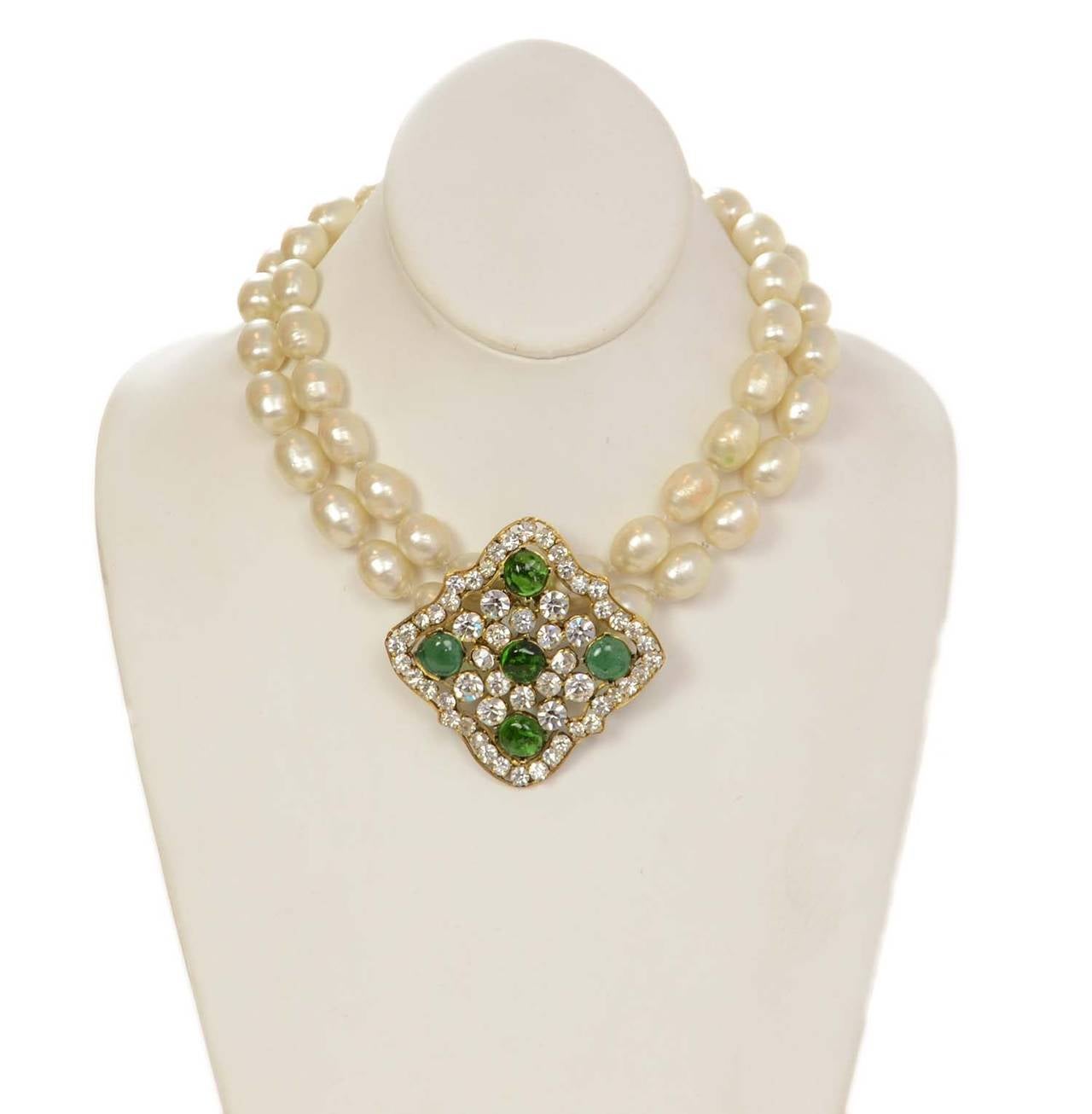 Chanel Vintage 2 Strand Pearl Necklace w/Rhinestone & Green Gripoix Pendant

    Made in: France
    Stamp: CHANEL CC MADE IN FRANCE
    Closure: Hook with adjustable length
    Color: Gold, ivory, and green
    Materials: Metal, faux pearls,