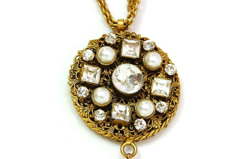 Chanel Vintage '84 Crystal Medallion & Pearl Drop Long Necklace

Made in: France
Year of Production: 1984
Stamp: CHANEL CC 1984
Closure: Lobster claw clasp
Color: Goldtone and ivory
Materials: Metal, rhinestones, and faux pearls
Overall Condition: