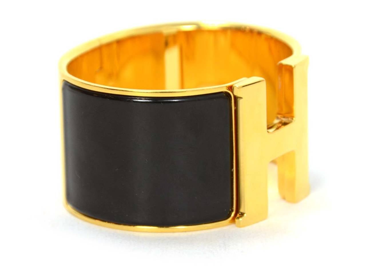 HERMES Black and Gold Extra-Wide Clic-Clac H Bracelet

-Made in: France
-Stamp: HERMES Made In France
-Closure: Classic clic-clac closure
-Color: Black and gold
-Materials: Enamel and Metal
-Overall Condition: Excellent pre-owned condition,