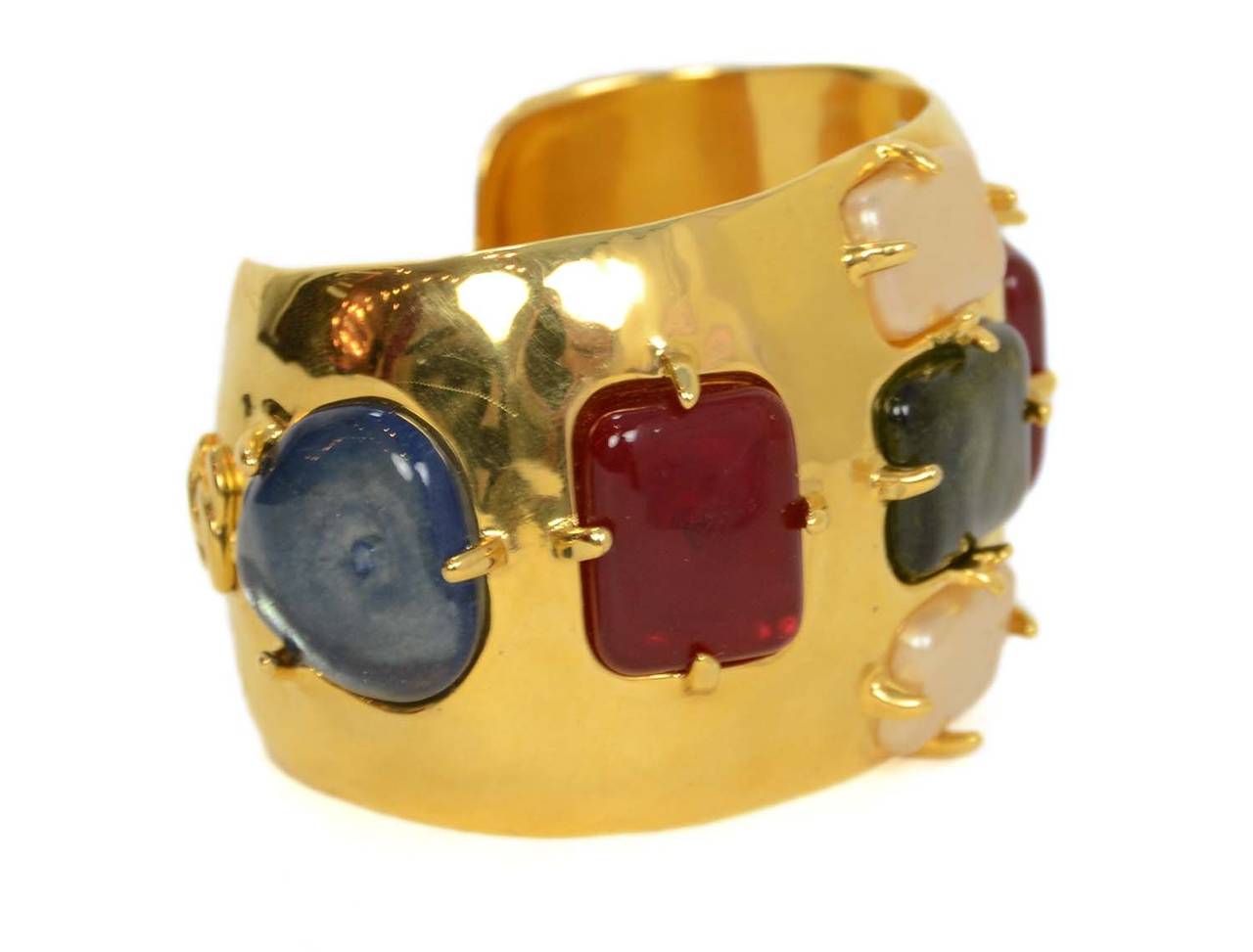 Chanel Vintage '97 Gold Cuff w/Red, Green, Blue & Ivory Stones

    Made in: France
    Year of Production: 1997
    Stamp: 97 CC A
    Closure: None
    Color: Gold, red, green, blue, and ivory
    Materials: Metal and poured glass
   