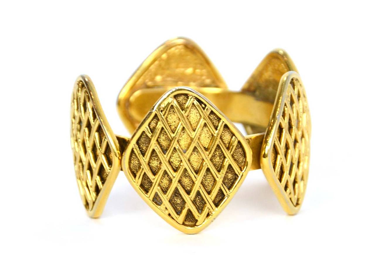Chanel Vintage '90s Gold Diamond Cuff 
Features five diamond shaped medallions with quilting

Made in: France
Stamp: Chanel
Closure: None
Color: Gold
Materials: Metal
Overall Condition: Very good condition.  Two of the medallions appear to be