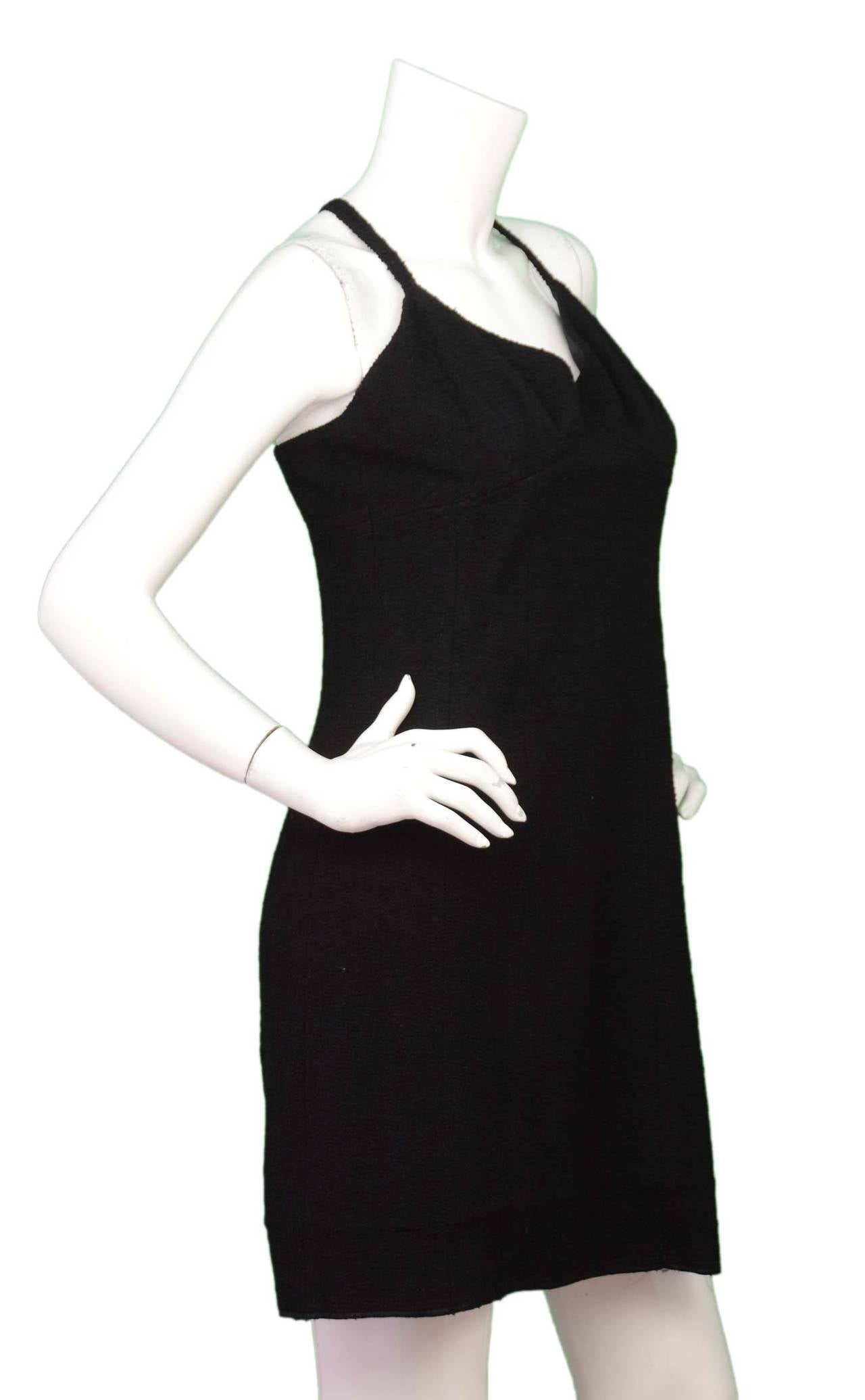 Chanel Vintage '94 Black Wool Spaghetti Strap Dress

    Made in: France
    Year of Production: 1994
    Color: Black
    Composition: 93% wool, 7% nylon
    Lining: Black, 100% silk
    Closure/opening: Back center zipper
    Exterior