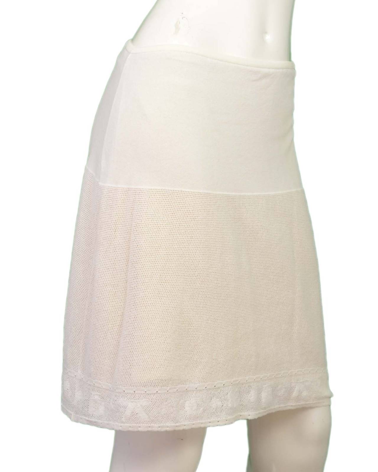 Chanel '03 White Perforated Stretch SkirtFeatures CC and bow design at hemline

    Made in: France
    Year of Production: 2003
    Color: White
    Composition: 80% cotton, 20% polyester
    Lining: Beige, 94% silk, 6% spandex
   