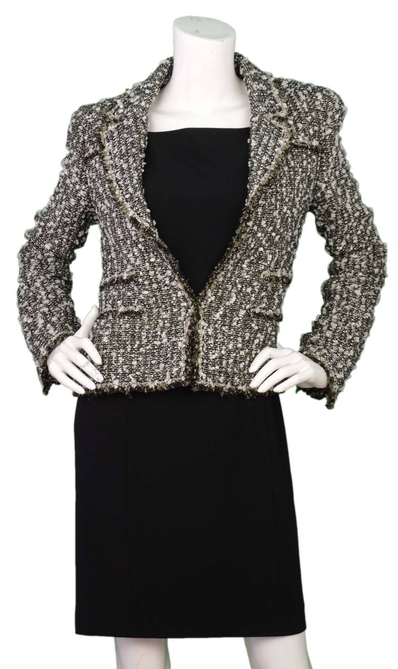 Chanel 2004 Black/White/Green Tweed Jacket sz 36
Features tinsel- like thread woven throughout to create a sparkle effect

    Made in: France
    Year of Production: 2004
    Color: Black, white, green and grey
    Composition: 46% rayon, 27%