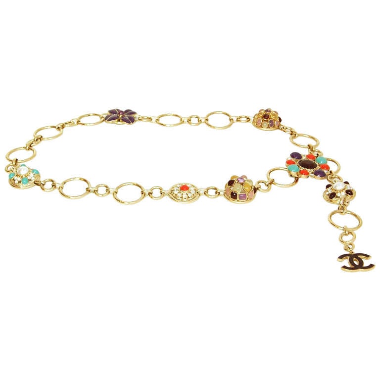 Chanel Gold Chain & Rhinestone Belt 
Features dangling CC charm

Made in: France
Year of Production: 2007
Color: Silvertone, red, teal and purple
Materials: Metal, glass stones and rhinestones
Closure: Hook closure
Stamp: 07 CC A
Retail Price: